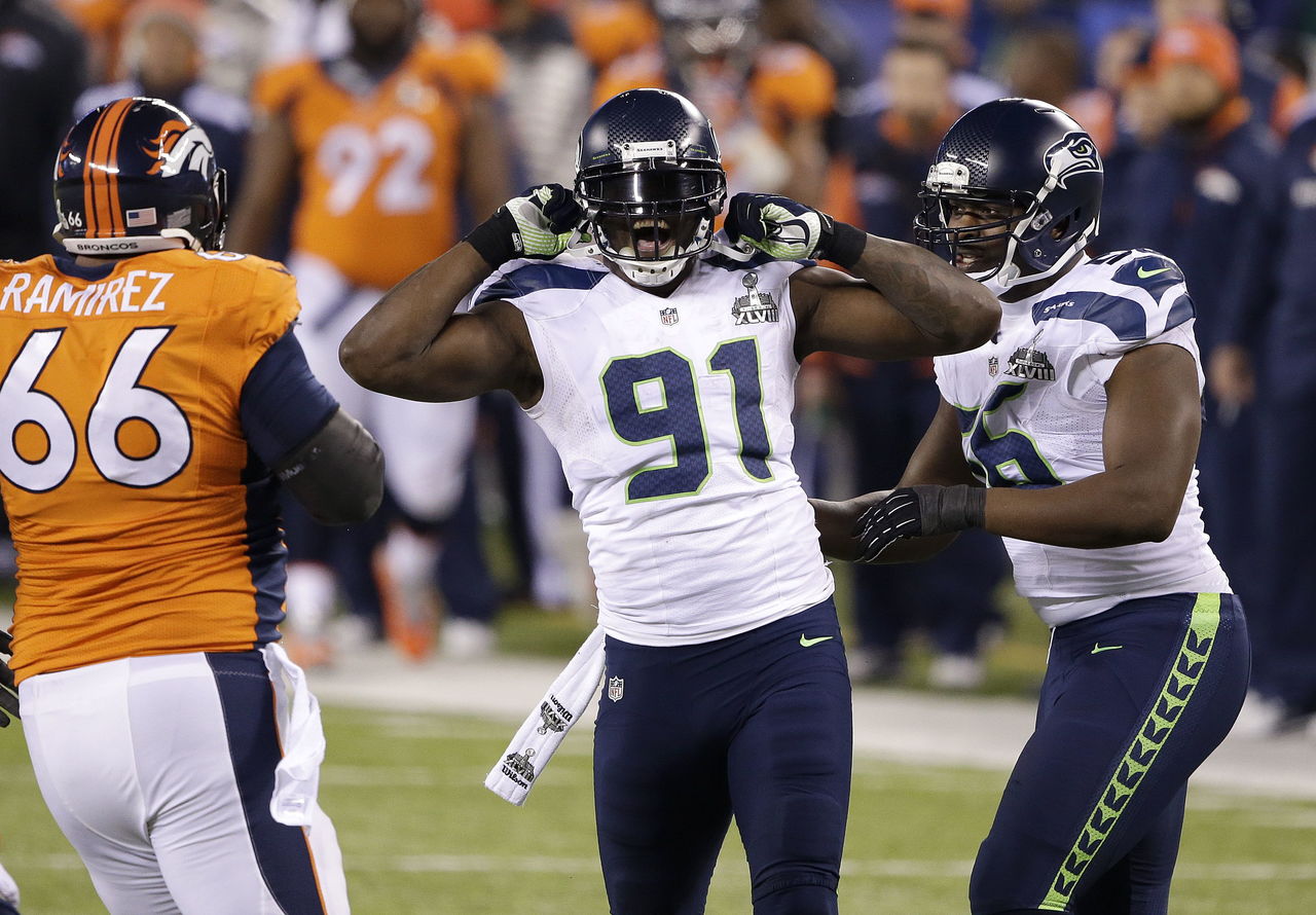 The Seahawks’ Chris Clemons (91) reacts to a defensive play next to Cliff Avril (56) and the Broncos’ Manny Ramirez (66) during Super Bowl XLVIII on Feb. 2, 2014.