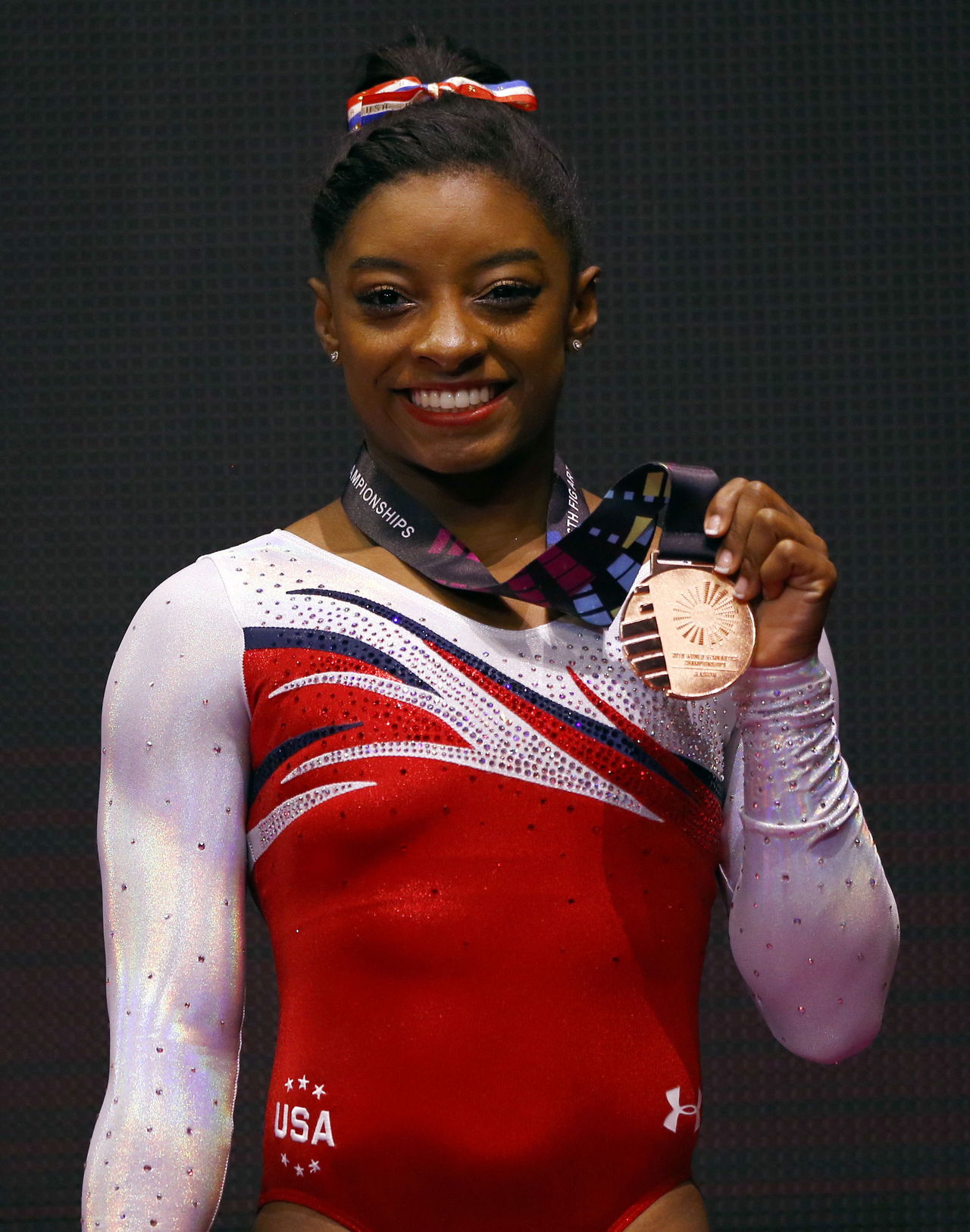 Simone Biles of the U.S. poses on the podium after the vault exercise at the World Artistic Gymnastics championships at the SSE Hydro Arena in Glasgow, Scotland on Oct. 31, 2015.