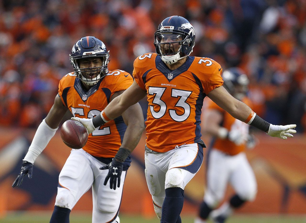 Denver Broncos defensive back Shiloh Keo (33) celebrates with teammate Corey Nelson following the AFC Championship game between the Broncos and the New England Patriots on Jan. 24 in Denver.