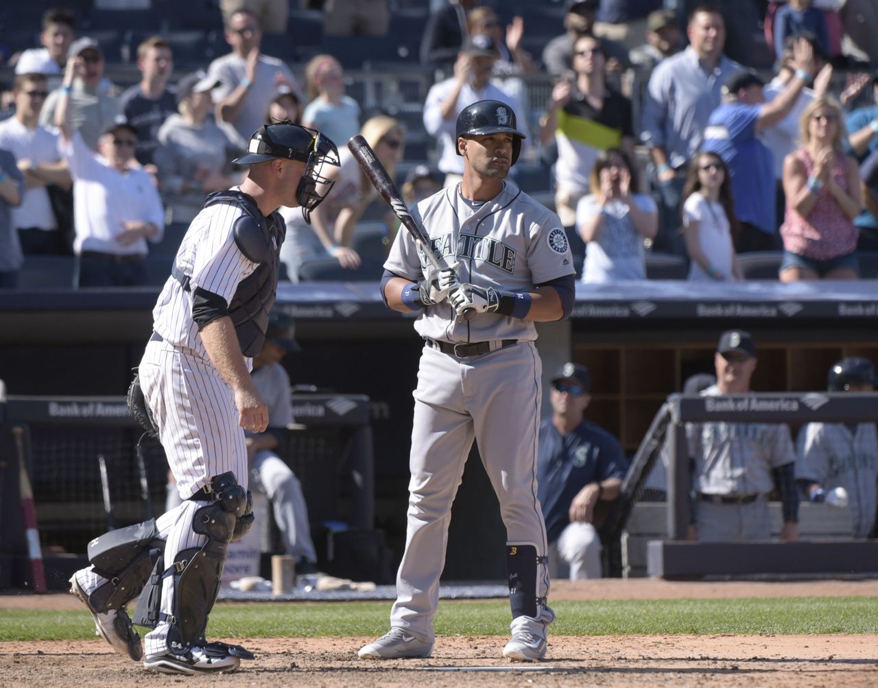 Mariners pinch hitter Franklin Gutierrez look on after striking out to end Sunday’s game as Yankees catcher Brian McCan walks away to congratulate New York pitcher Andrew Miller.