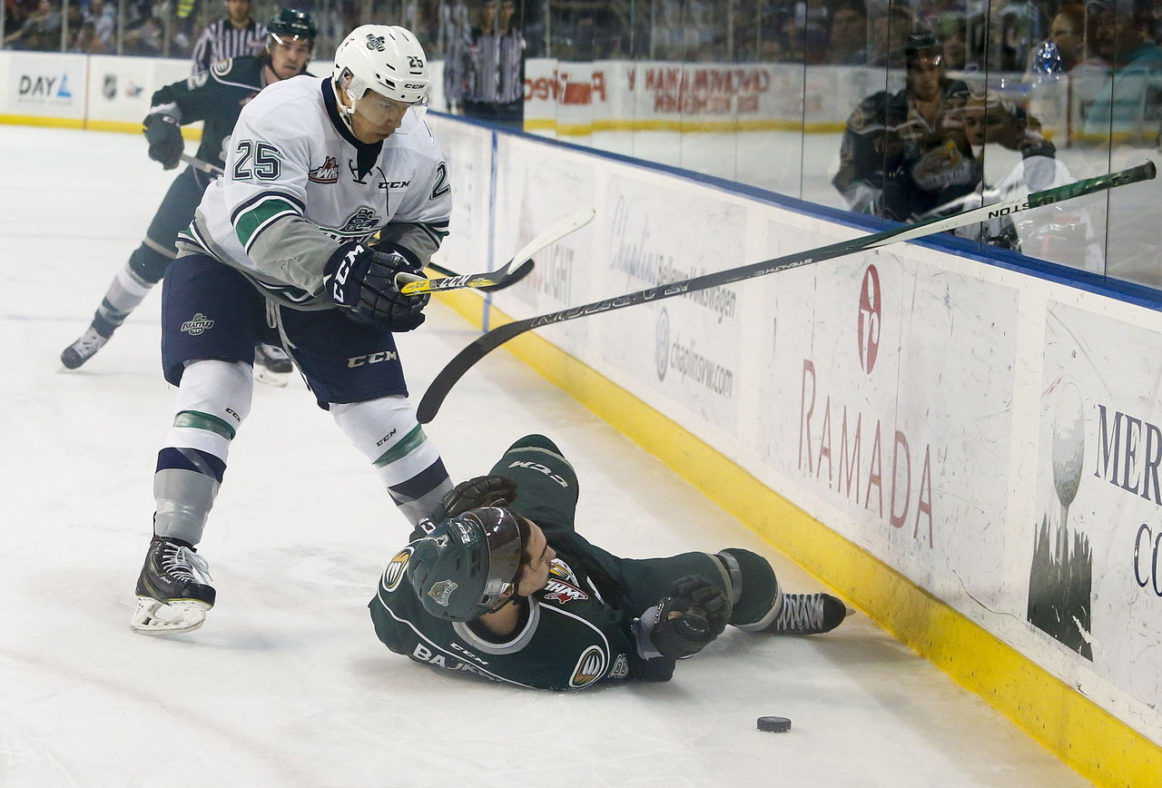 Silvertips right wing Patrick Bajkov (right) is knocked to the ground by Seattle’s Ethan Bear during Game 5 of a second-round playoff series Saturday at ShoWare Center in Kent.