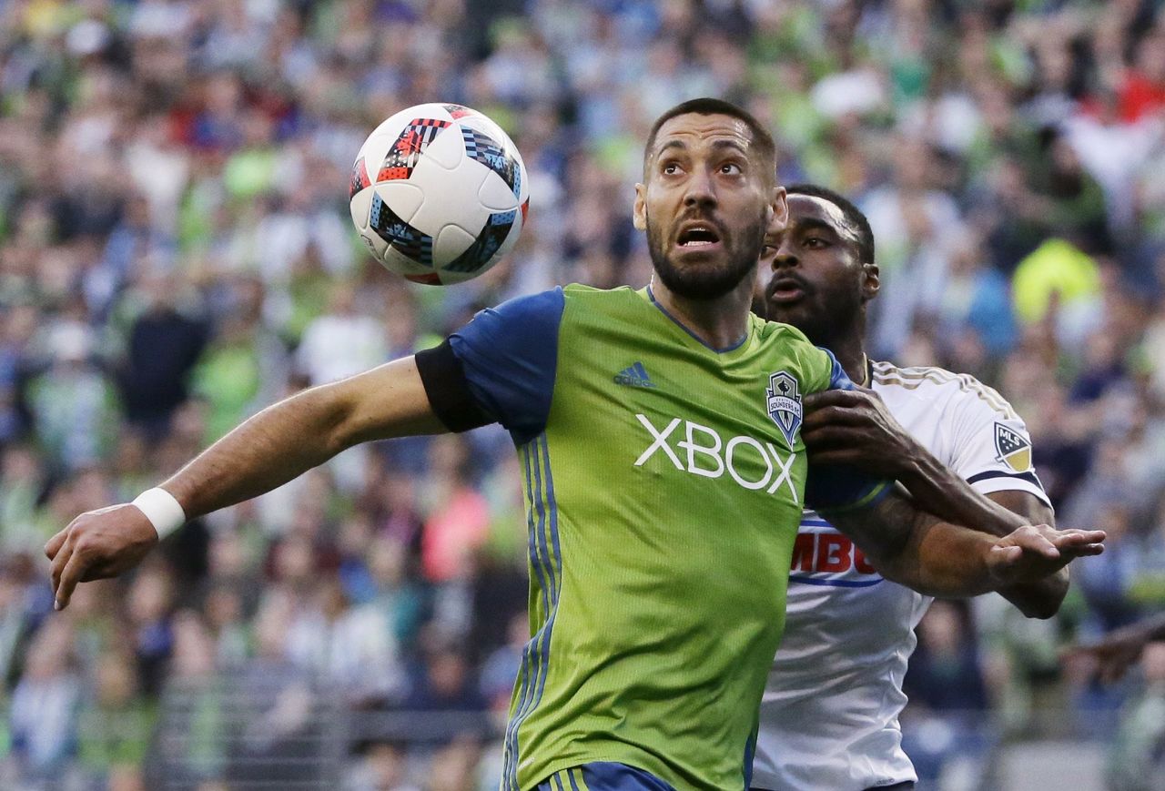 The Sounders’ Clint Dempsey and the Union’s Warren Creavalle eye the ball during the first half of Saturday’s game.