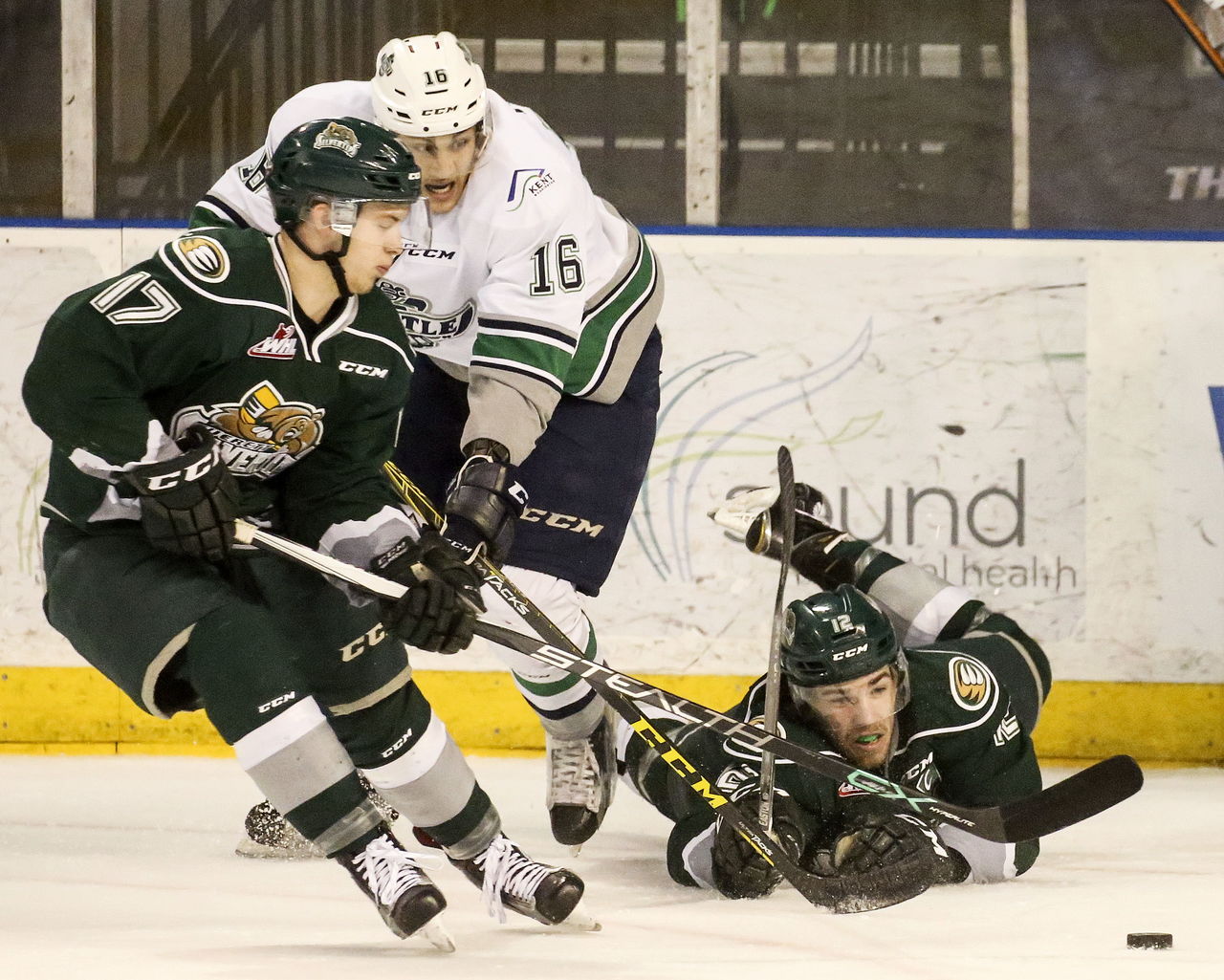 The Silvertips’ Matt Fonteyne (left) and Dawson Leedahl (right) battle for the puck with the Thunderbirds’ Alexander True during a playoff game Sunday afternoon at the ShoWare Center in Kent.