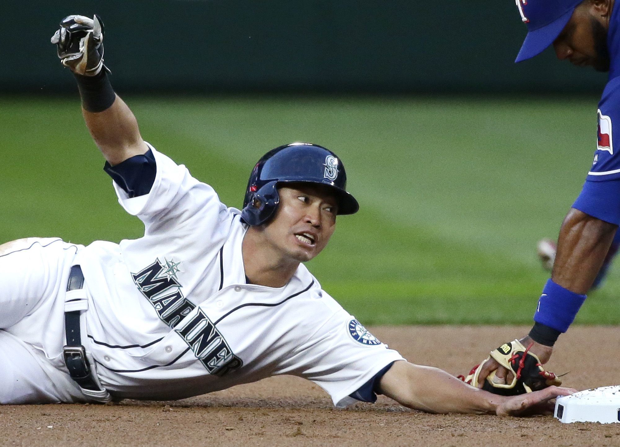 The Mariners’ Nori Aoki is tagged out by Rangers shortstop Elvis Andrus as he attempts to steal second base in the first inning of Monday’s game.