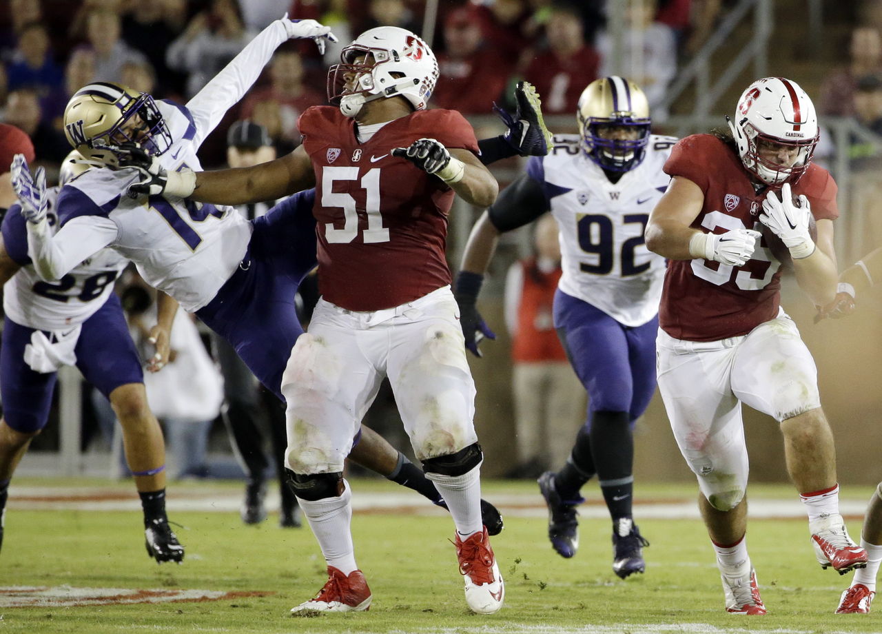 Stanford guard Joshua Garnett (51) levels Washington defensive back JoJo McIntosh (14) during a game last season.