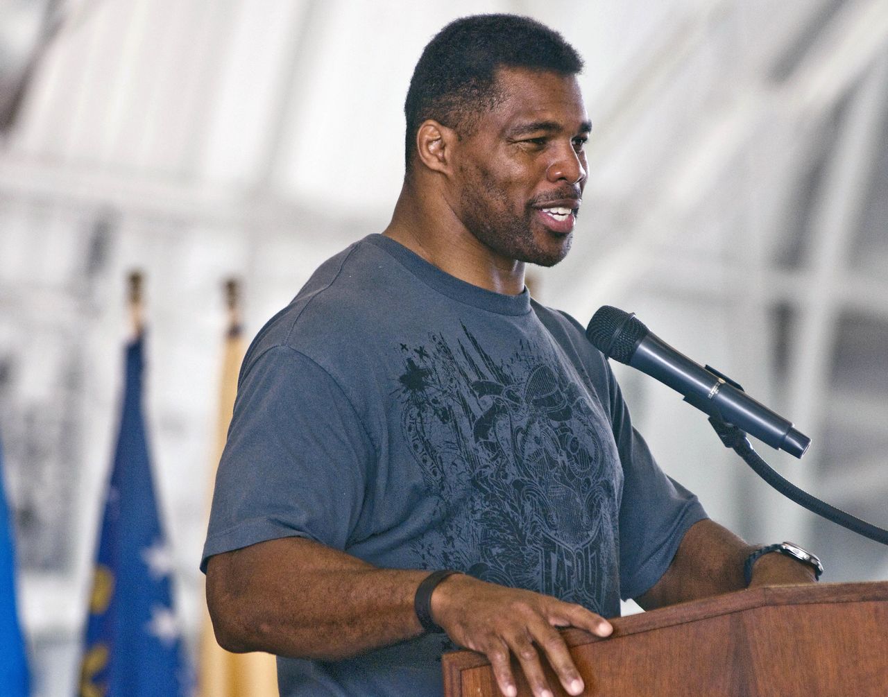 In this March 22, 2012, photo, former NFL football player Herschel Walker speaks to airmen at Eglin Air Force Base, Florida.