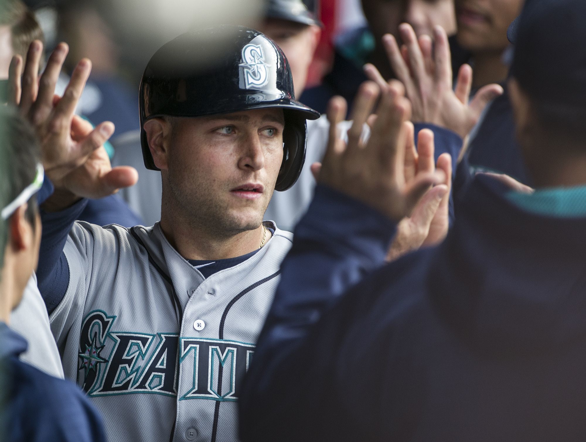 The Mariners Chris Iannetta is congratulated in the dugout after scoring on a two-run by the Mariners Nori Aoki in the second inning of Wednesday’s game.