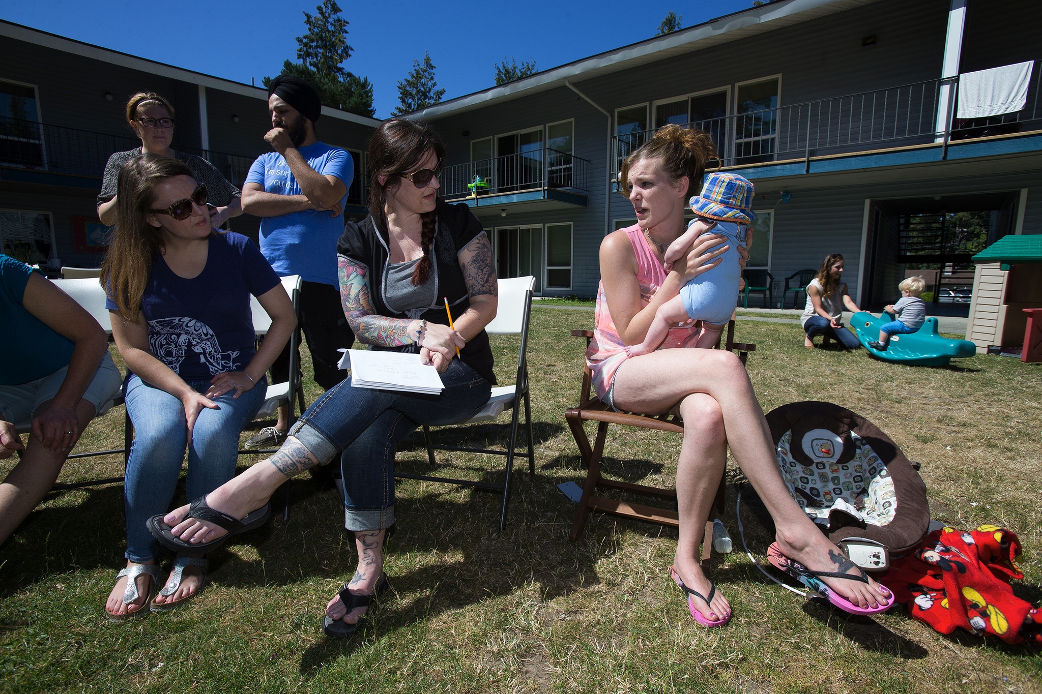 Andy Bronson / The Herald                                At YWCA’s Trinity Place in Lynnwood, registered nurses Libby Church and Natalie Anderson, of UW Bothell’s School of Nursing and Health Studies, listen to resident Bonnie Geveshausen, right, talk about health concerns.