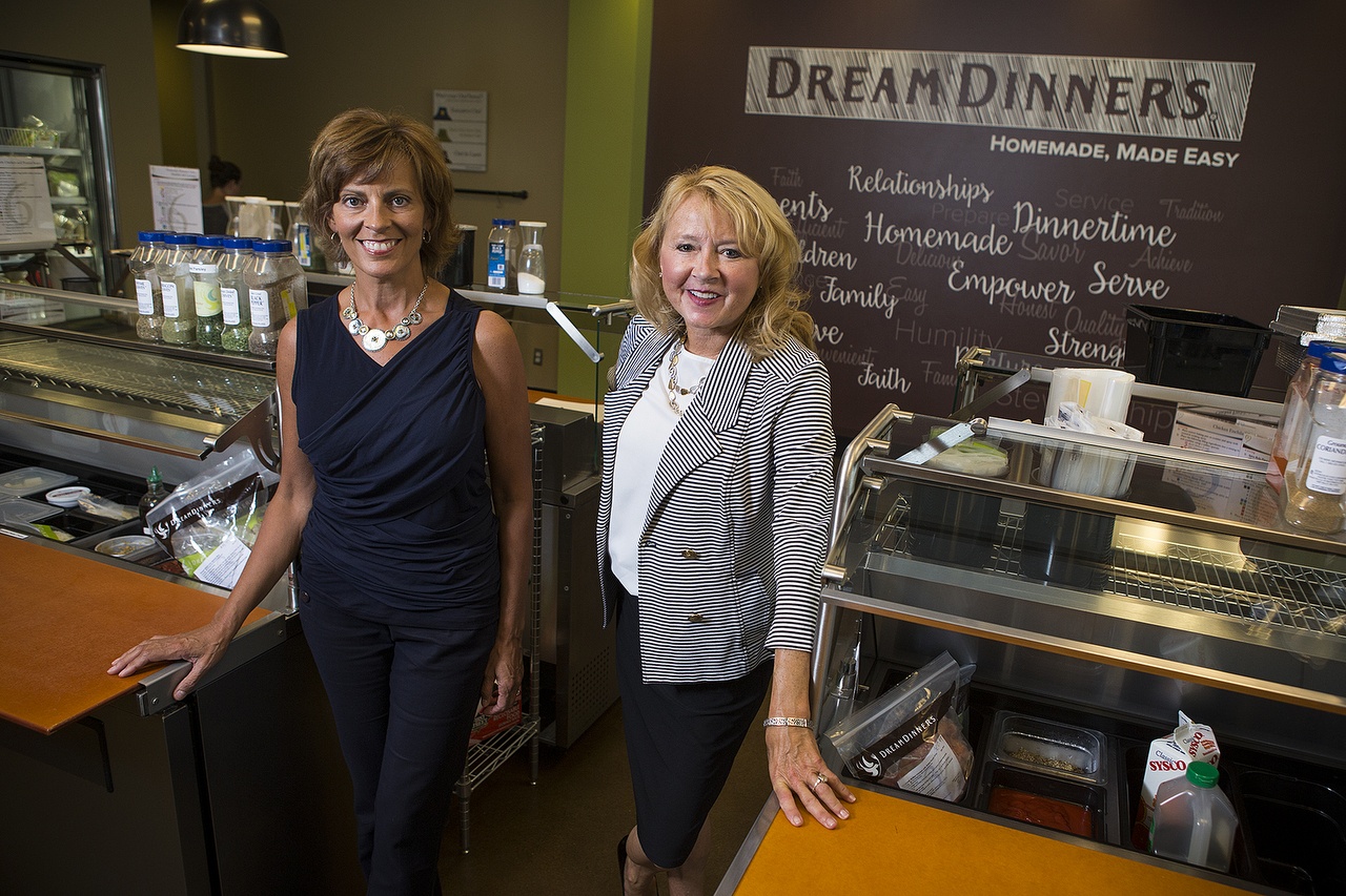 Dream Dinners co-founders Stephanie Allen (center) and Tina Kuna opened their first shop in Everett in 2002 and have since grown to 87 locations in 25 different states. (Ian Terry / The Herald)