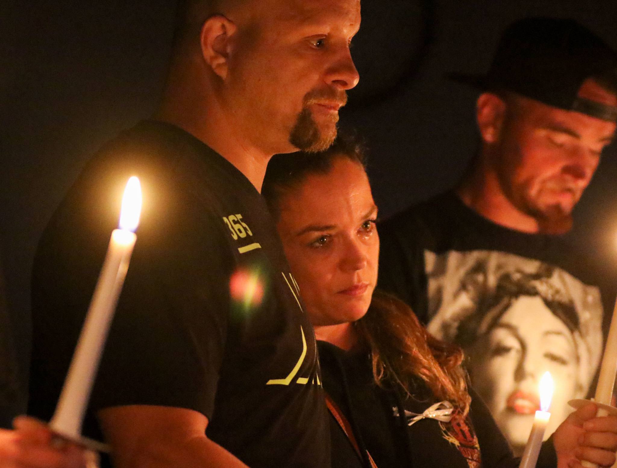 Shawn Lucca (from left), Mary Yeldon and Anthony Cecotti attend the candlelight vigil held by Hope Soldiers in honor of International Overdose Awareness Day at Mukilteo Foursquare Church in August. (Kevin Clark / The Herald)