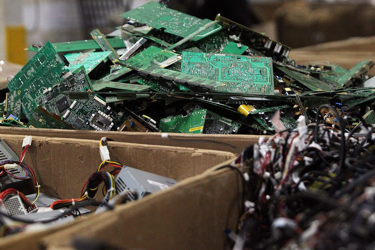 Piles of wires, motherboards and other electronic parts fill boxes at E-Waste Recycling Center, in December 2014. (Genna Martin / Herald file photo)