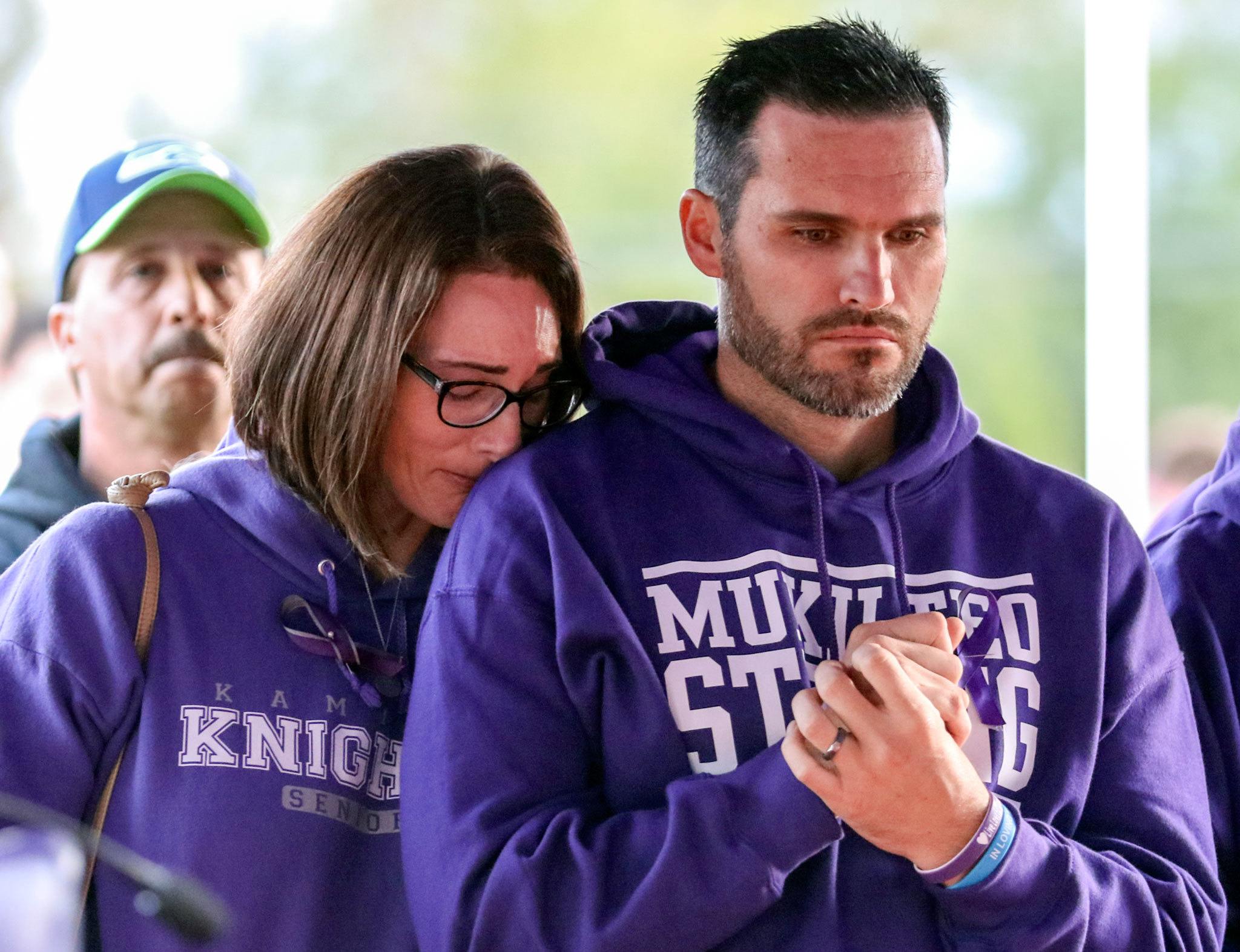 Nikki Ebner (left) and Brad Ebner stand vigil for their son, Jordan Ebner, during a memorial service before Kamiak’s game against Bishop Blanchet Friday night at Goddard Stadium in Everett. (Kevin Clark / The Herald)