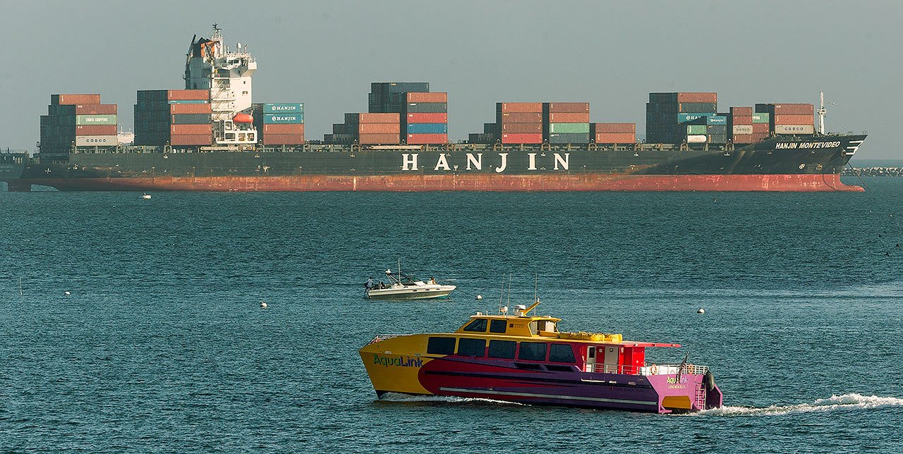 The container ship Hanjin Montevideo (top) of South Korea’s Hanjin Shipping Co. is anchored outside the Port of Long Beach in California on Thursday. (AP Photo/Damian Dovarganes)