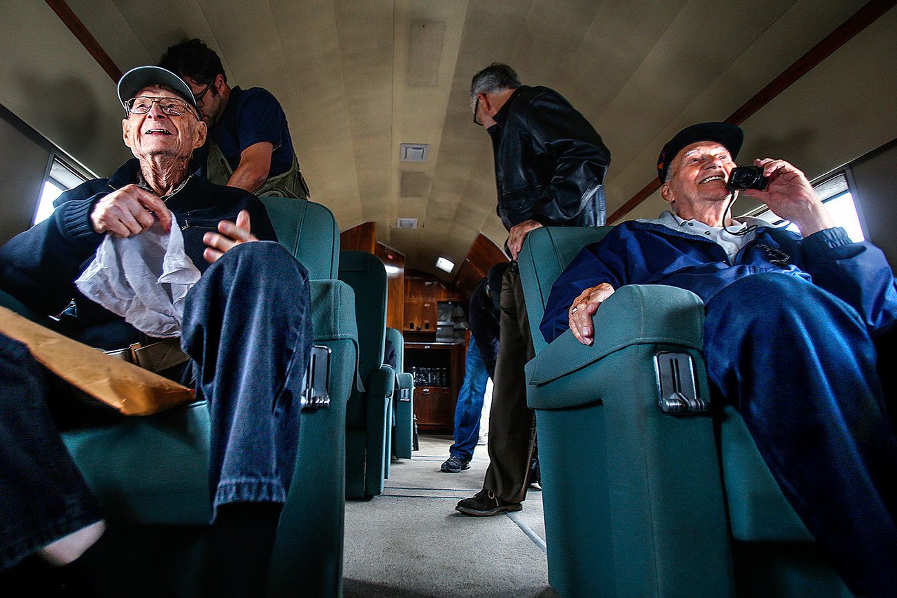 During a pre-flight talk to the passengers, Historic Flight Foundation president John Sessions warned that, although no injuries have occurred on previous flights, one possilble side effect can be facial strain caused by excessive smiling. Preparing for take off, only moments after boarding, it appears that World War II pilots Elden Larson (left) and Art Unruh, both 93, are already showing symptoms. (Dan Bates / The Herald)