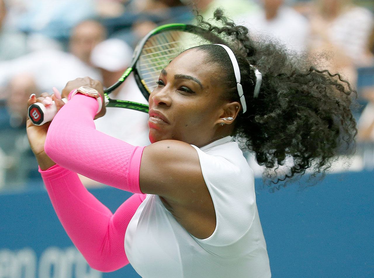 Serena Williams returns a shot to Johanna Larsson during a straight-set victory in the third round of the U.S. Open on Saturday in New York. (AP Photo/Jason DeCrow)