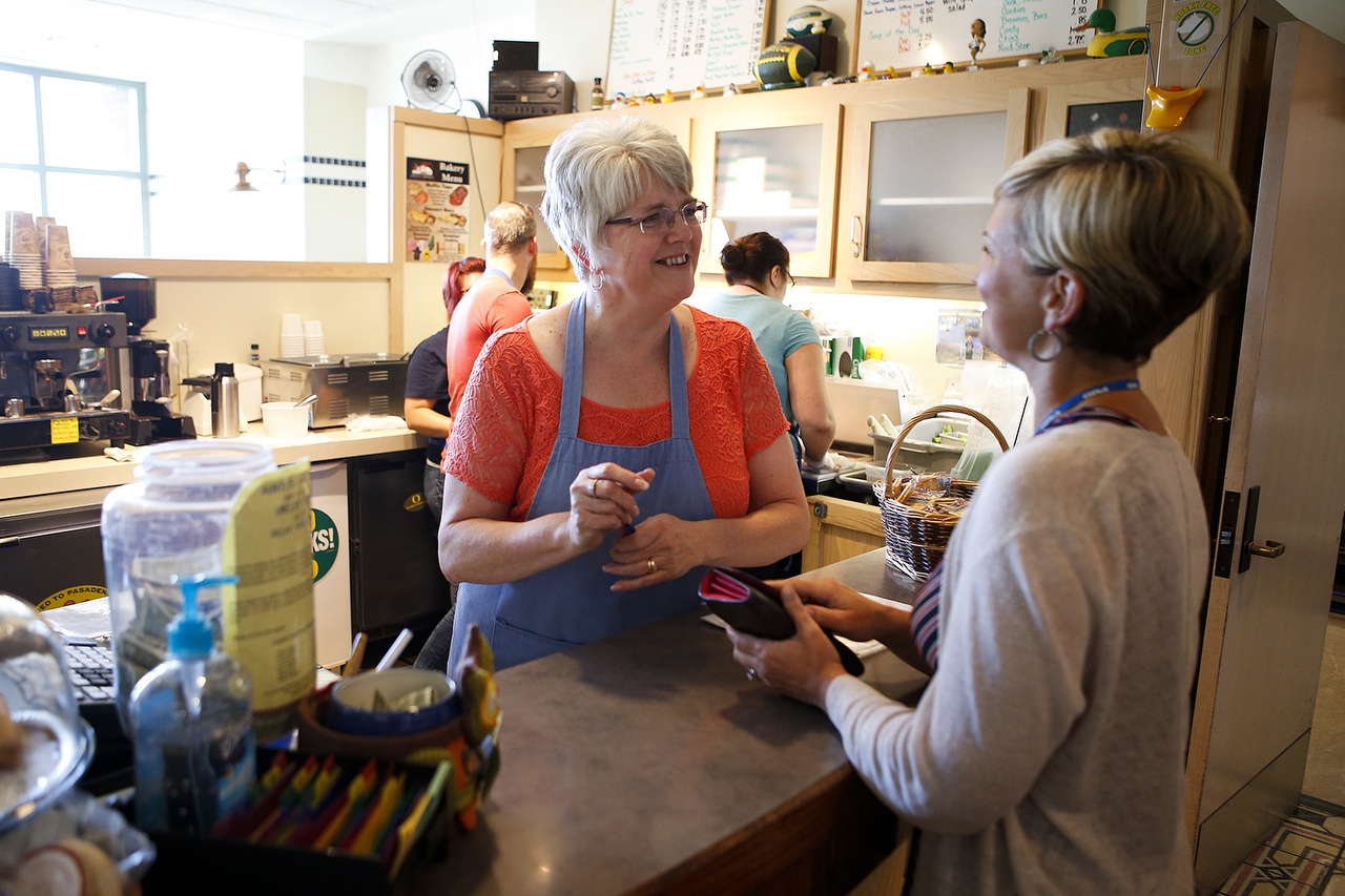 Cassie Golden (center) helps customer Brenda White at the PUDeli in Everett. “They take such good care of us,” said White, who works at the PUD and has made the PUDeli a regular lunch stop for the past eight years. (Ian Terry / The Herald)