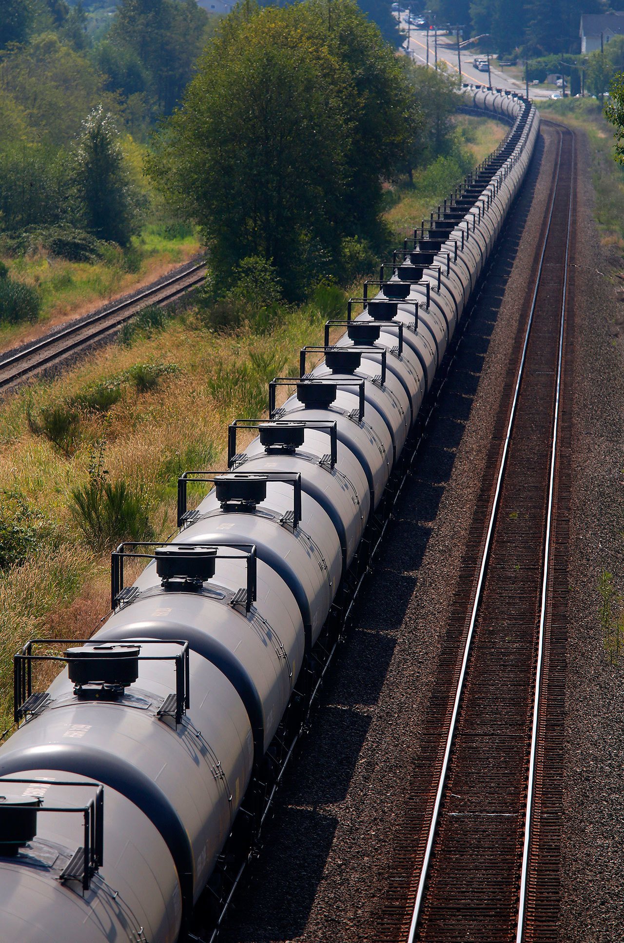 A train comprised of tank cars, each with the placard 1267 denoting that the tank carries crude oil, waits on the tracks going through Lowell in Everett in August 2014. (Mark Mulligan / Herald file photo)