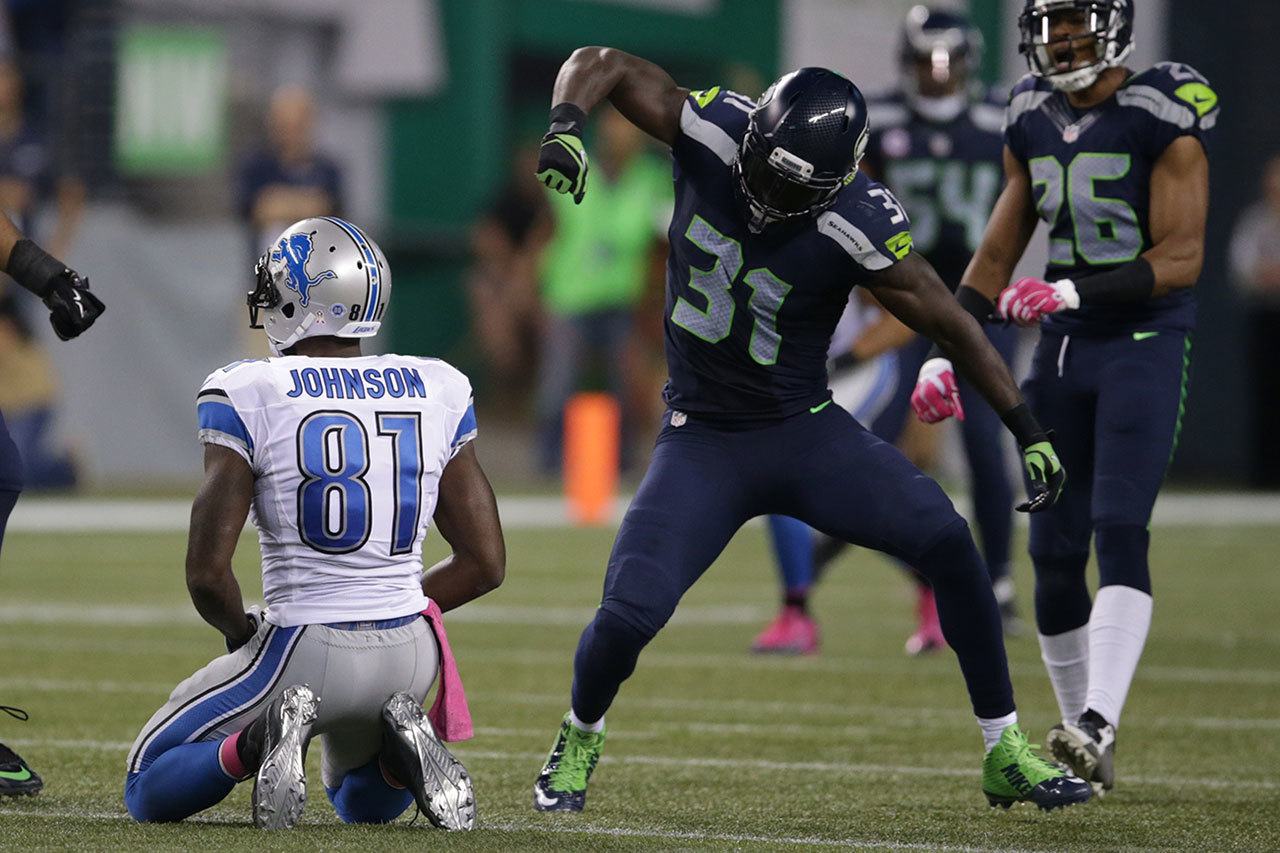 Seahawks strong safety Kam Chancellor (31) celebrates after a hard hit on Lions wide receiver Calvin Johnson (81) during a game Oct. 5, 2015, in Seattle. (AP Photo/Scott Eklund)