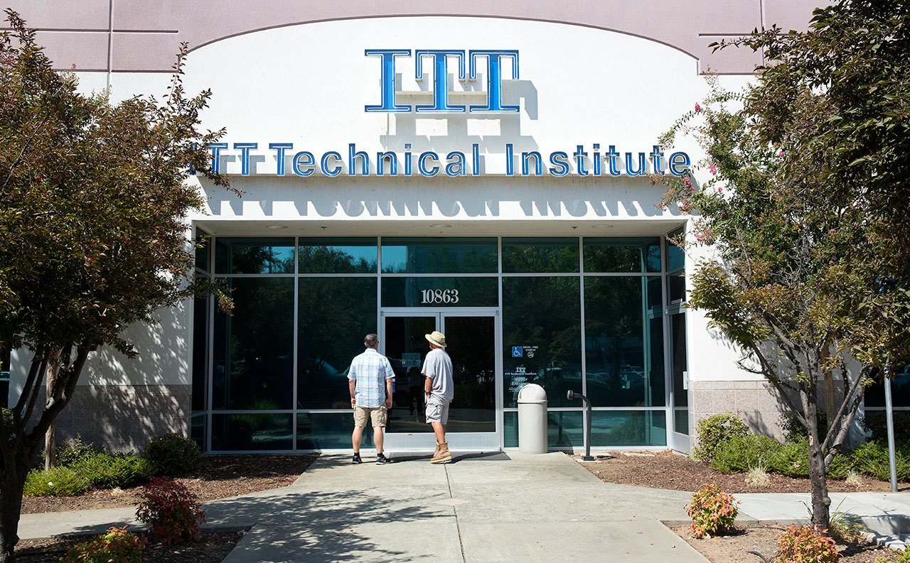Harold Poling (left) and Ted Weisenberger found the doors to the ITT Technical Institute campus in Rancho Cordova, Calif., closed after ITT Educational Services announced that the schools had ceased operating nationwide on Tuesday. (AP Photo/Rich Pedroncelli)