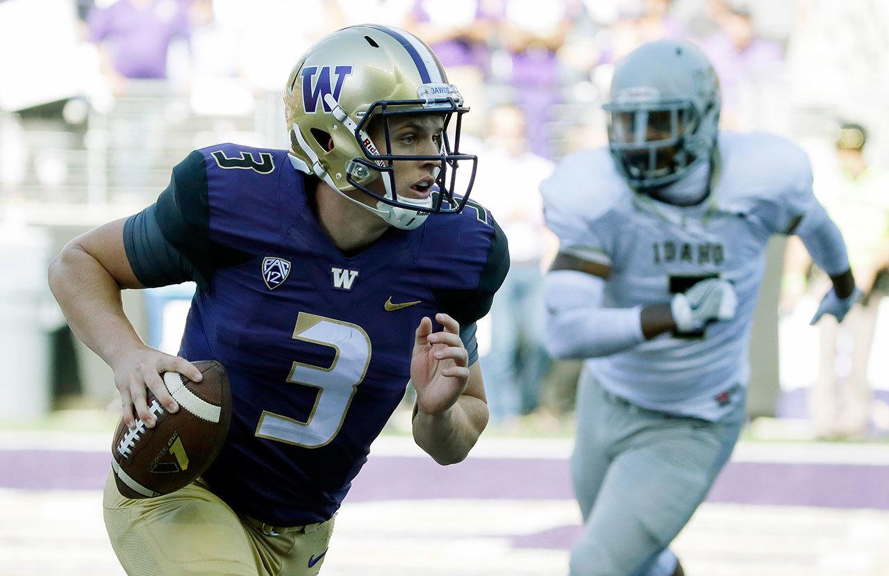 Washington quarterback Jake Browning (3) scrambles against Idaho during the Huskies’ 59-14 victory over the Vandals on Saturday in Seattle. Browning threw five touchdown passes in the game. (AP Photo/Ted S. Warren)