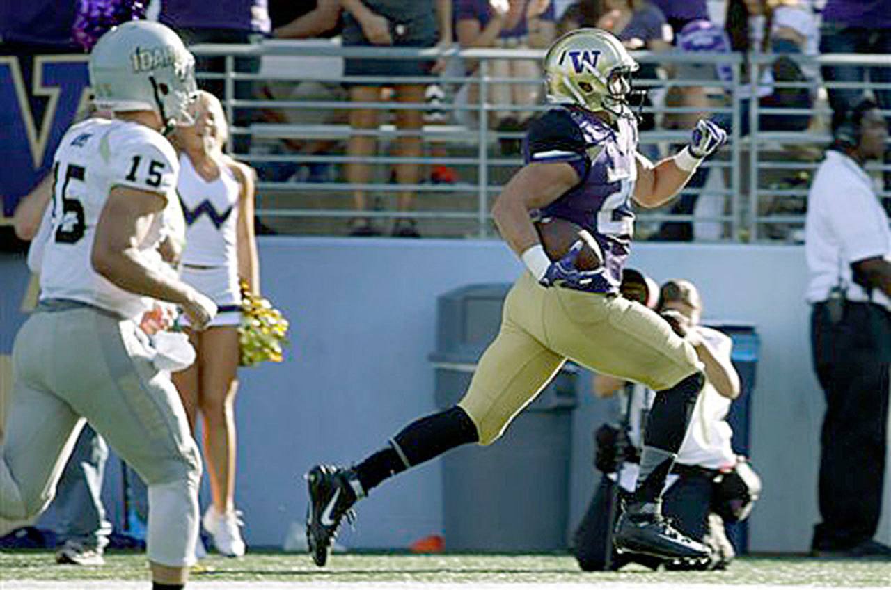 Washington’s Connor O’Brien (right) returns an interception for a touchdown during the second half of the Huskies 59-14 win over Idaho on Sept. 10 in Seattle. (AP Photo/Ted S. Warren)