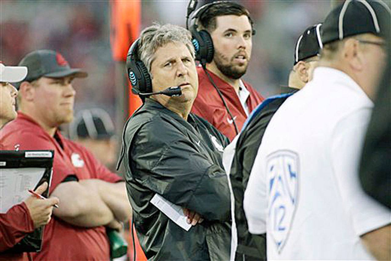 Washington State coach Mike Leach, shown here during the Cougars’ game against Eastern Washington on Sept. 3, has complained that the media and local police are unfairly focusing on the actions of his football players. (AP Photo/Young Kwak)