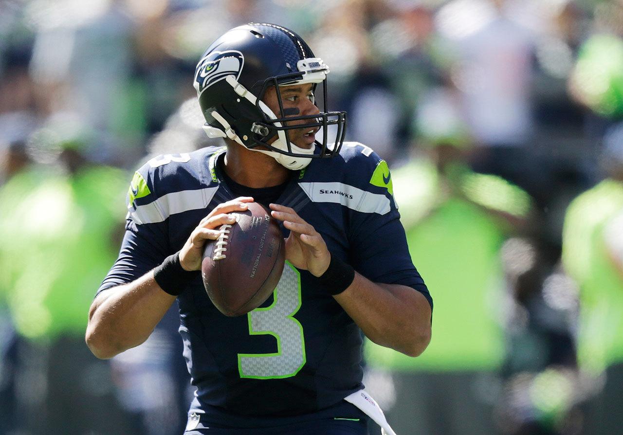 Seahawks quarterback Russell Wilson passes against the Dolphins in the first half of a game this past Sunday in Seattle. (AP Photo/Stephen Brashear)