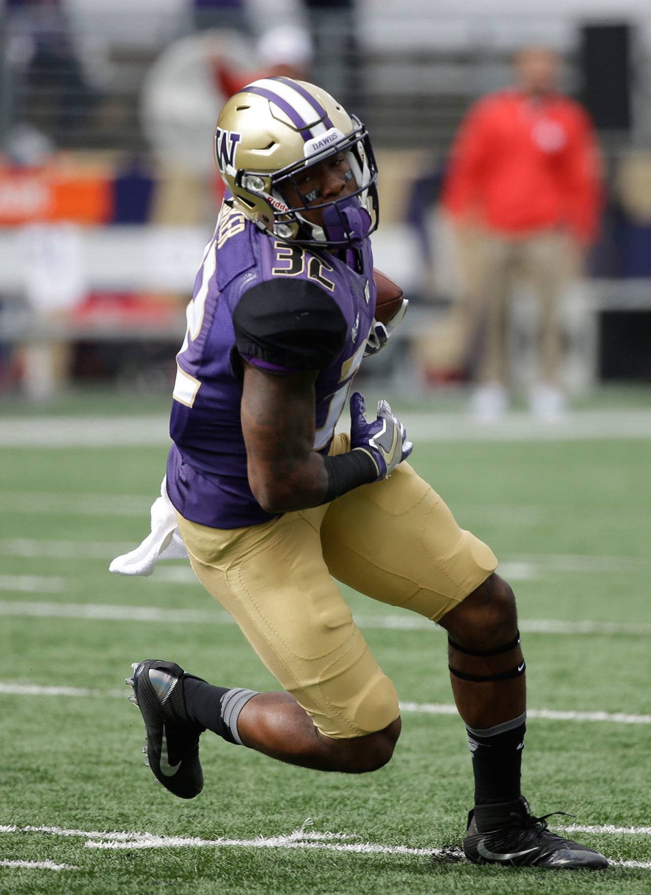 Washington’s Budda Baker runs the ball during a game against Rutgers on Sept. 3 in Seattle. (AP Photo/Elaine Thompson)