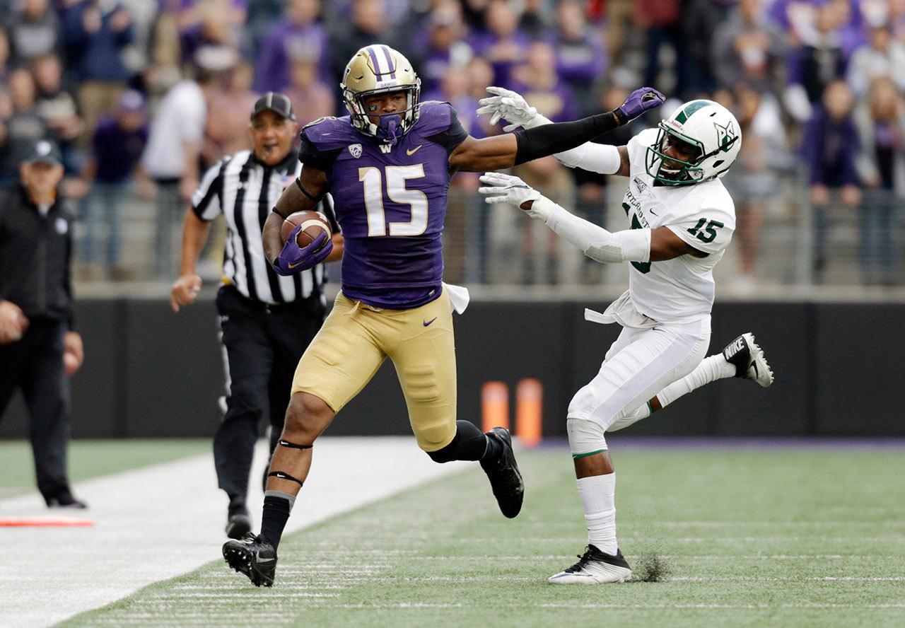 Washington tight end Darrell Daniels attempts to evade Portland State safety Tyler Foreman after catching a pass in the first half of a game on Sept. 17 in Seattle. Washington won 41-3. (AP Photo/John Froschauer)