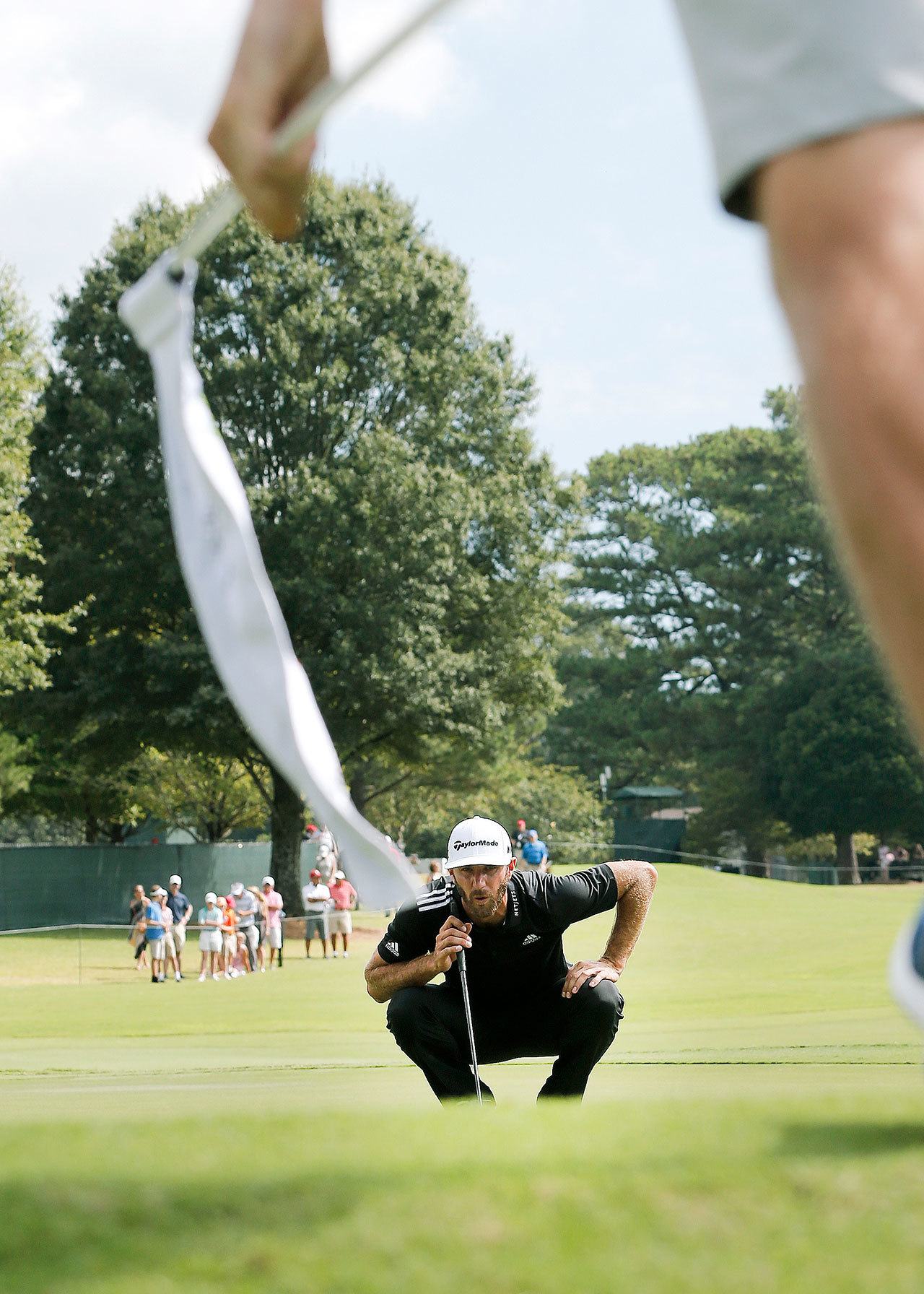 Dustin Johnson lines up a putt on the fifth hole during the third round of play at the Tour Championship at East Lake Golf Club on Saturday in Atlanta. Johnson is tied with Kevin Chappell going into Sunday’s final round. (AP Photo/John Bazemore)