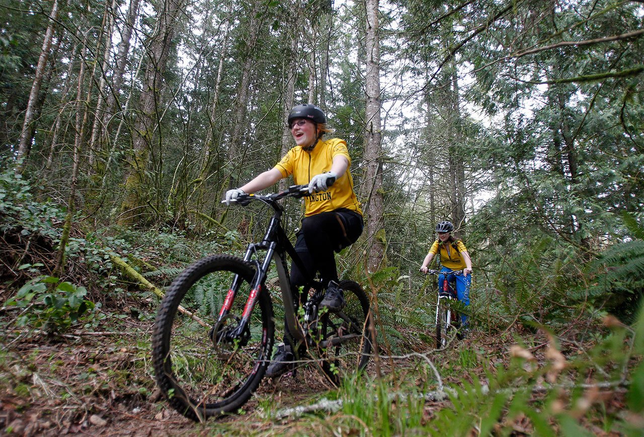 Hannah Mendro (left) and Nicholle Ayres, with the Lakewood-Arlington Cycling Club Mountain Bike Team make their way down a small section of trail in March of 2012. (Jennifer Buchanan / Herald file photo)