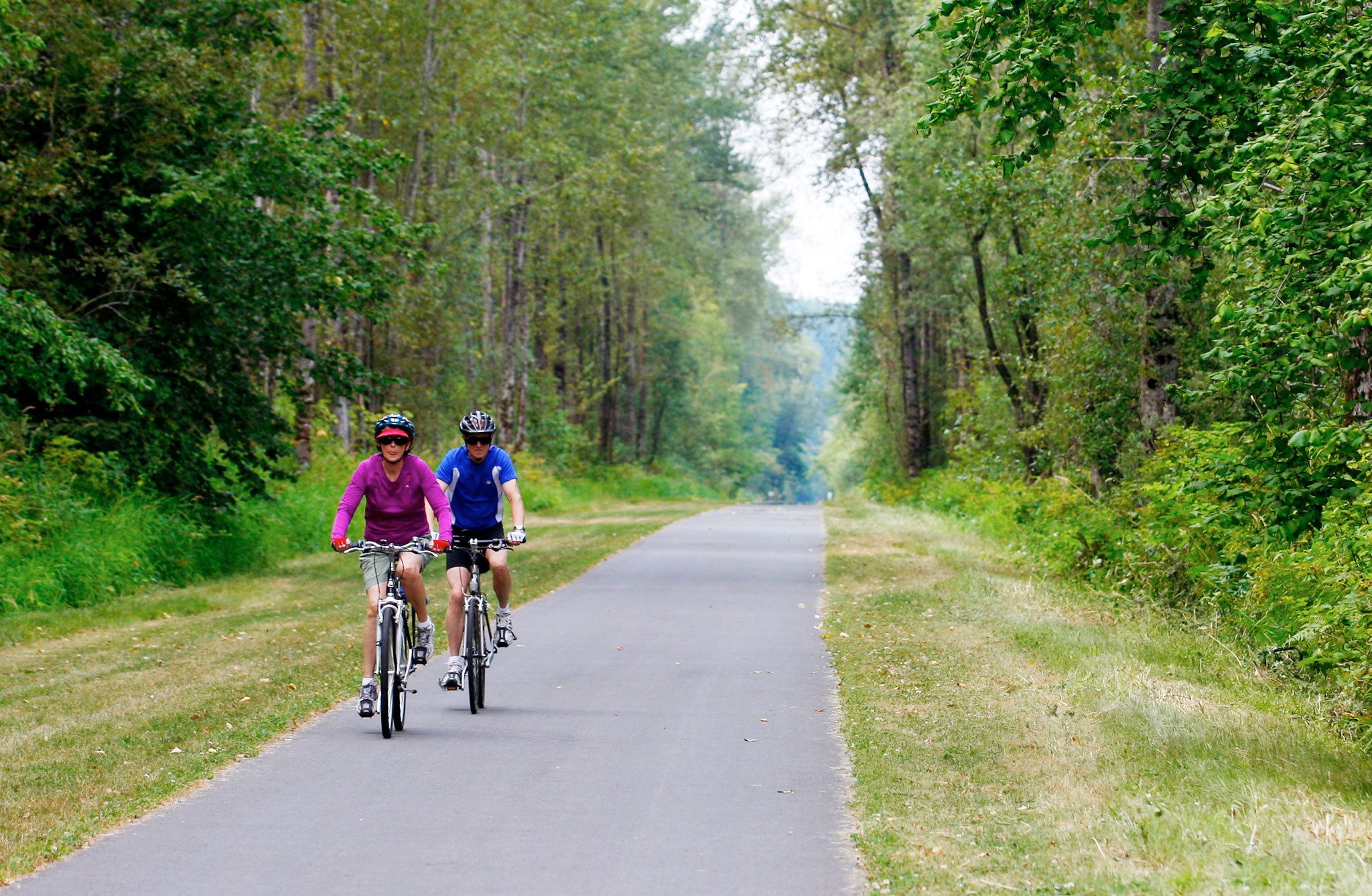 Jean Olson and her husband, Donald, of Arlington, ride south on the Centennial Trail outside of Bryant before turning around and heading back to the Nakashima Heritage Barn. “We like to come out once every week or so,” Donald said. (Herald file, July 31, 2013)