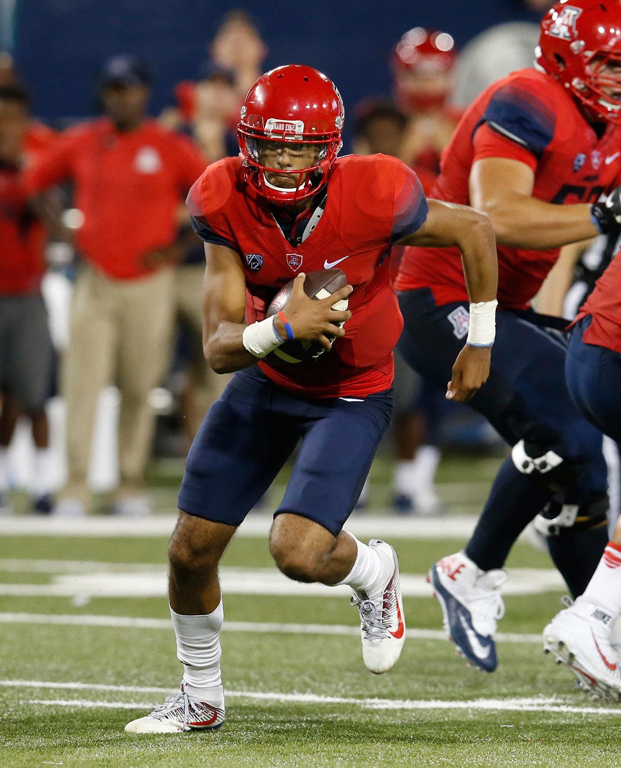 Arizona quarterback Brandon Dawkins scrambles during the first half of a game against Grambling State on Sept. 10 in Tucson, Ariz. (AP Photo/Rick Scuteri)