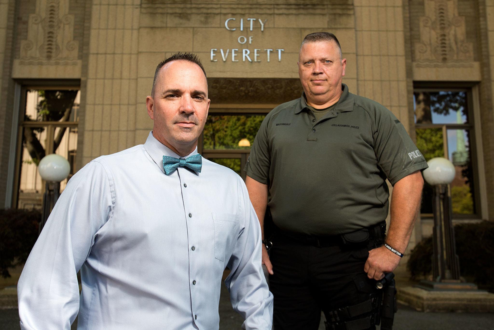 Everett Police detectives Mike Atwood (left) and Jim Massingale, now a patrolman with the Stillaguamish Tribe of Indians, stand in front of the Everett Police Department on Tuesday. After two years, they are confident that their investigation has confirmed the authenticity of a lost 9/11 flag. (Andy Bronson / The Herald)