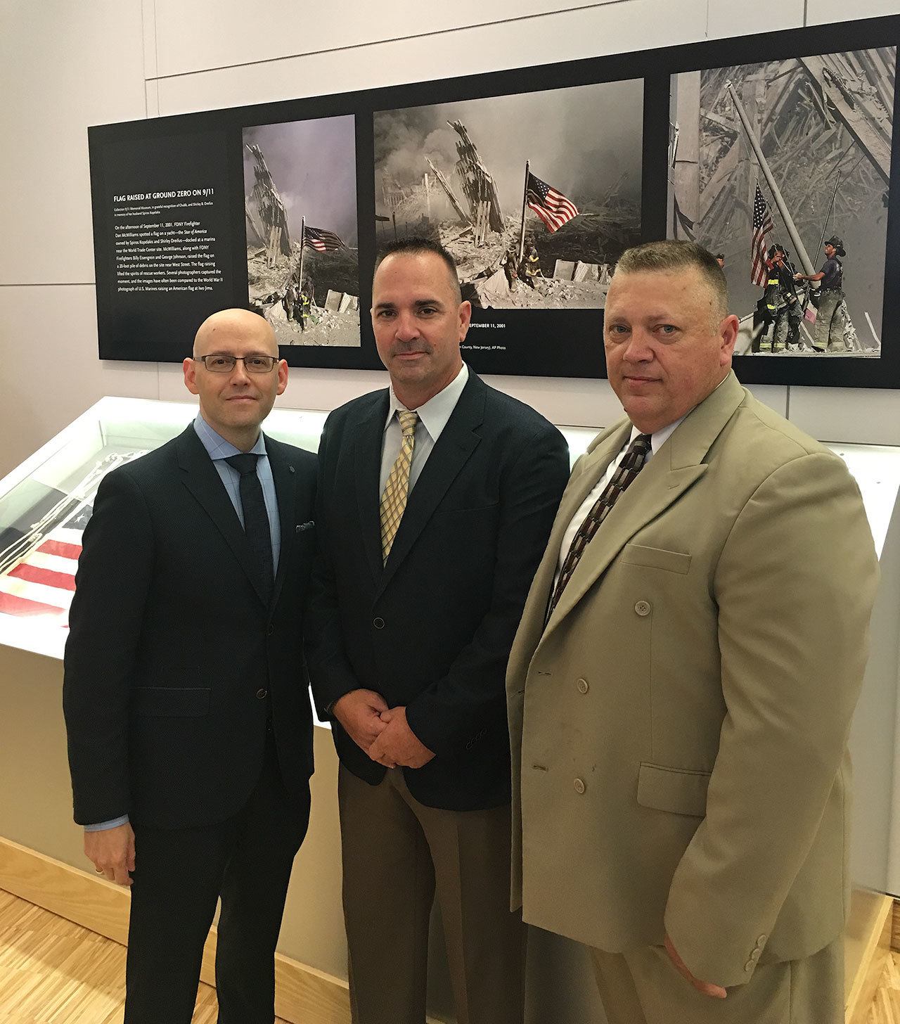 Author and History Channel host Brad Meltzer (from left), and Everett Police detectives Mike Atwood and Jim Massingale, now with the Stillaguamish Tribe, attend the unveiling of the lost flag, Thursday in New York. (City of Everett)