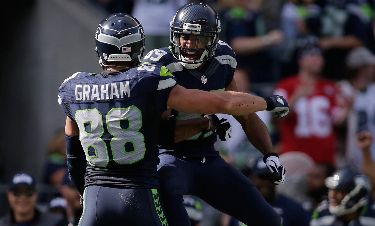 Seahawks tight end Jimmy Graham (88) celebrates one of his six receptions with teammate Doug Baldwin during Sunday’s NFL game in Seattle. (AP Photo/John Froschauer)