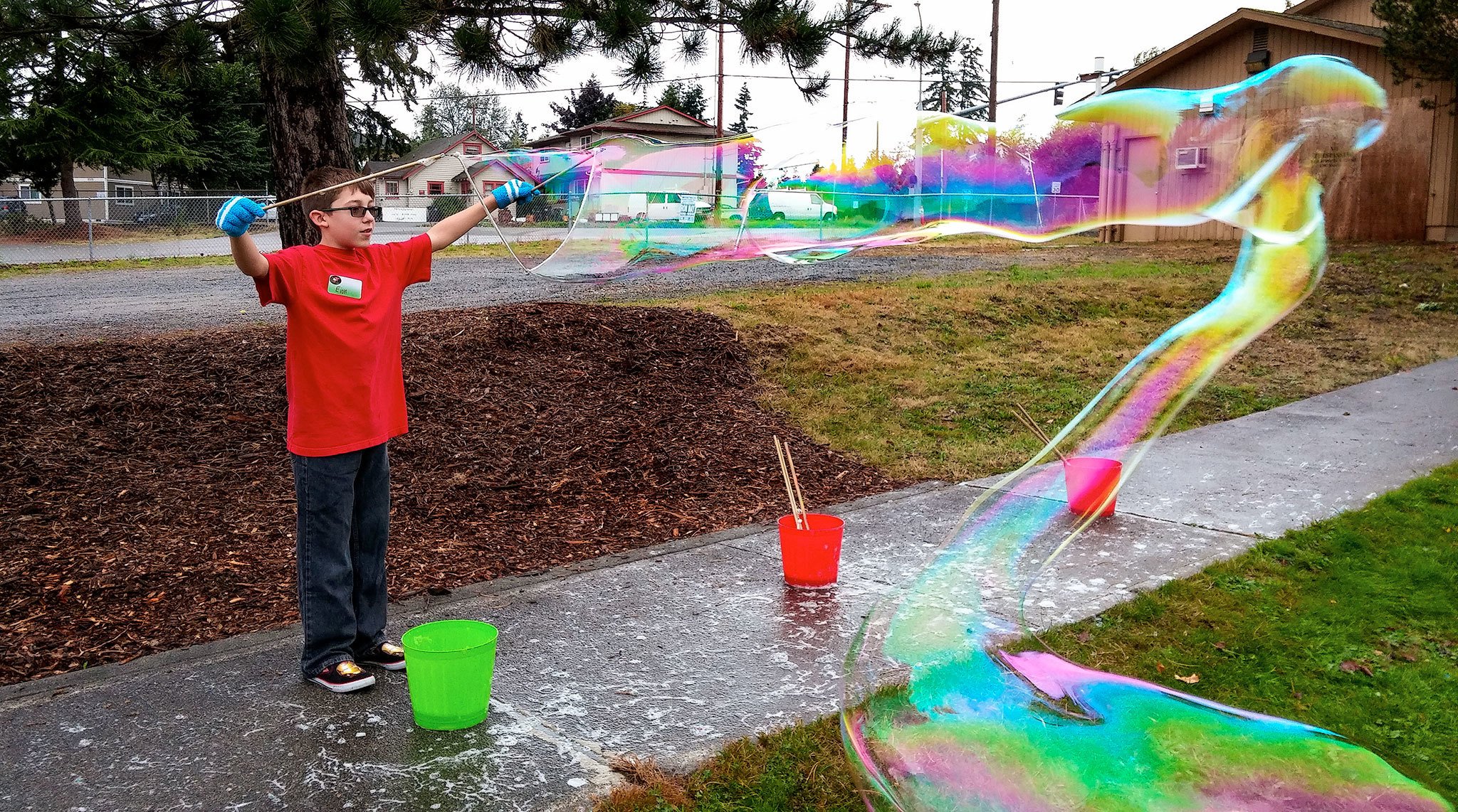 Eion Mclaughlin, 12, of Everett, creates a long bubble during the Bubbleology event Saturday at the Everett Public Library’s Evergreen Branch in Everett. (Rikki King / The Herald)