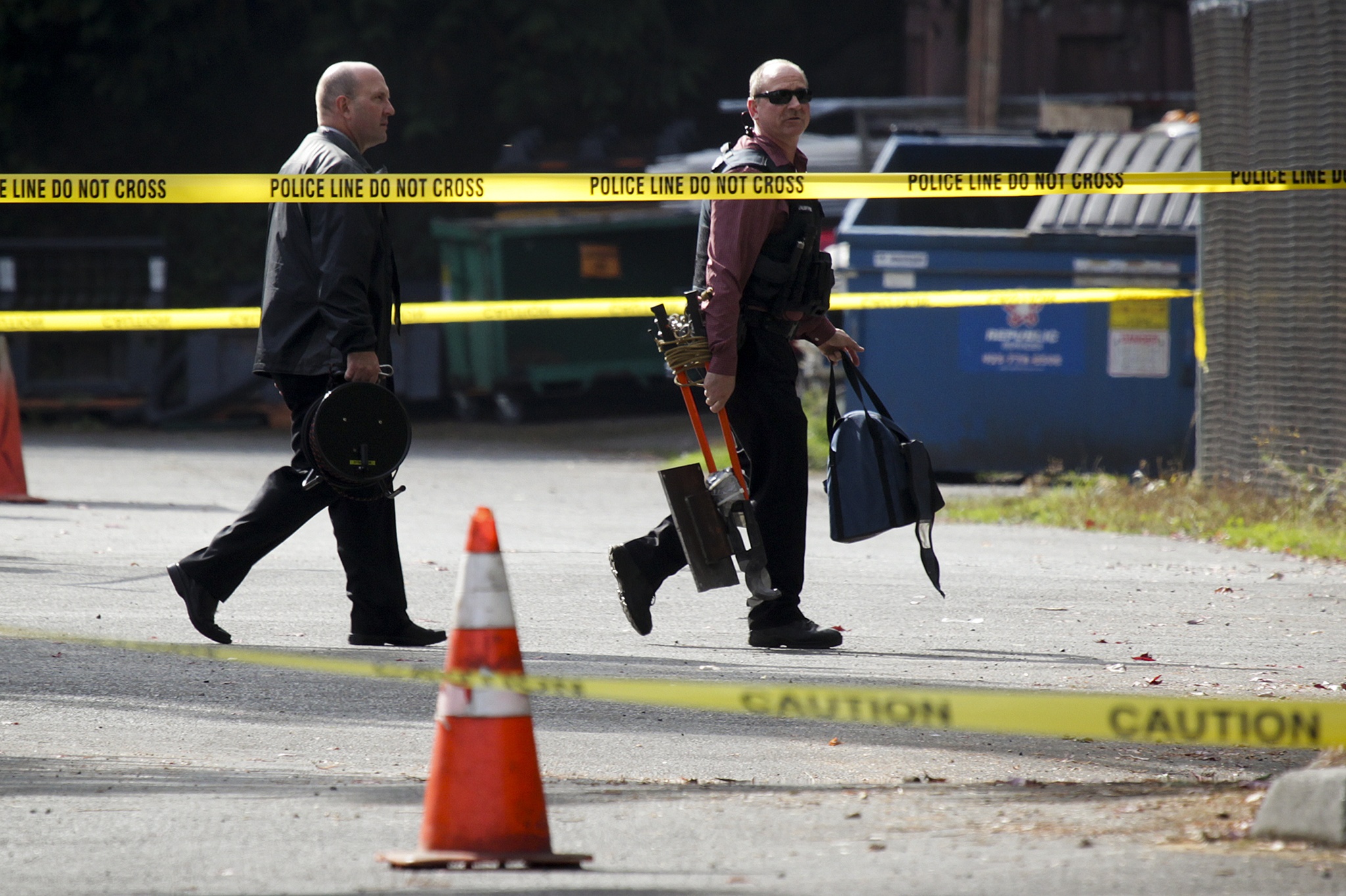 Law enforcement make their way into a parking lot near Edmonds Community College’s north complex after a suspicious device was found in an impounded vehicle by Mill Creek Police on Thursday morning. The device was rendered benign and the area was deemed safe at 11:45 a.m. (Ian Terry / The Herald)