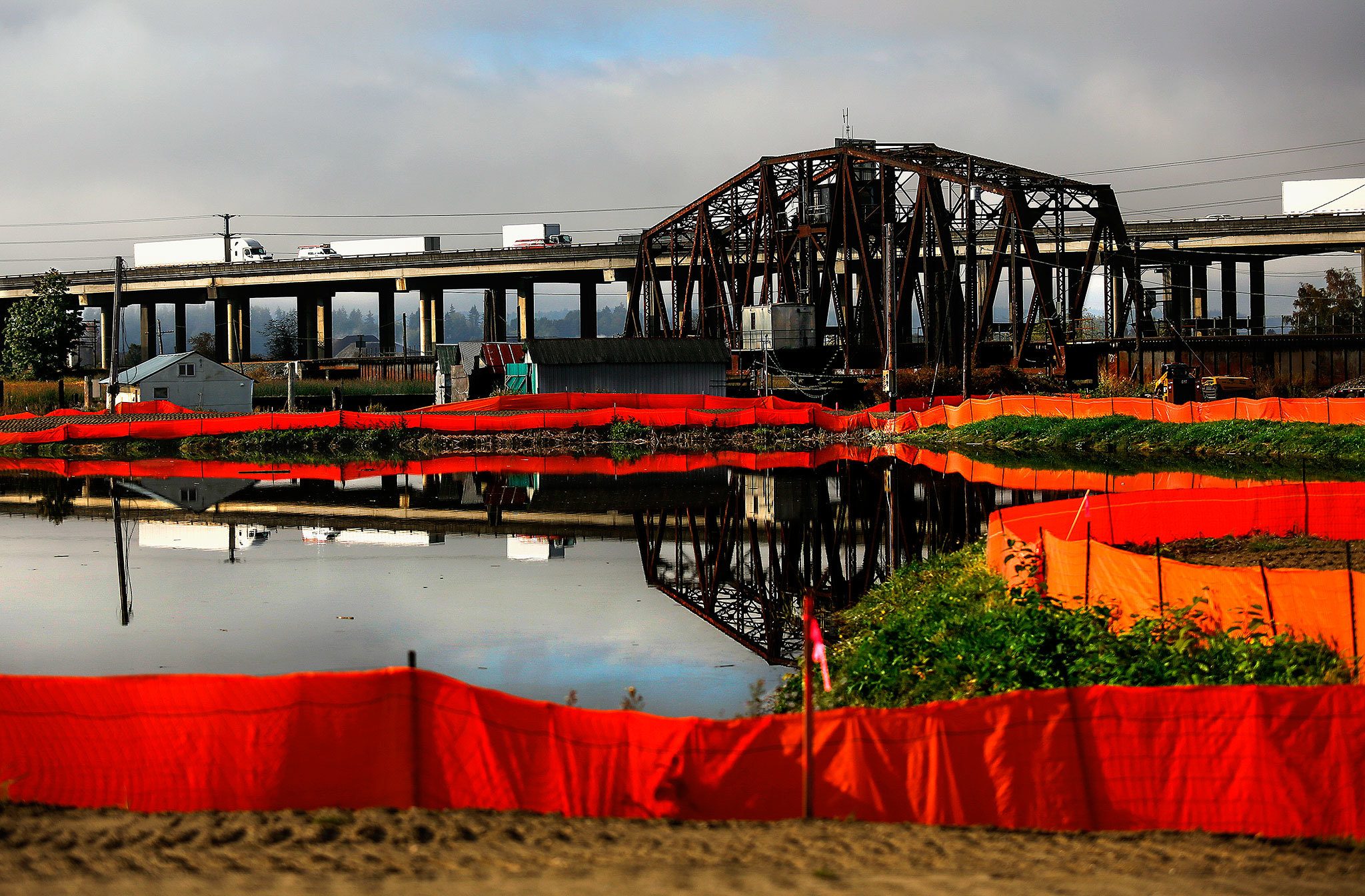 Yeah, but can they get those truck reflections out of the water? Marysville is in the process of cleaning up and converting the former Geddes Marina into a park. That involves putting down a six-inch cap of clean fill and cloth to isolate any contaminants that may be there. Later a layer of sand will be laid on the lagoon bottom for the same reason. (Dan Bates / The Herald)