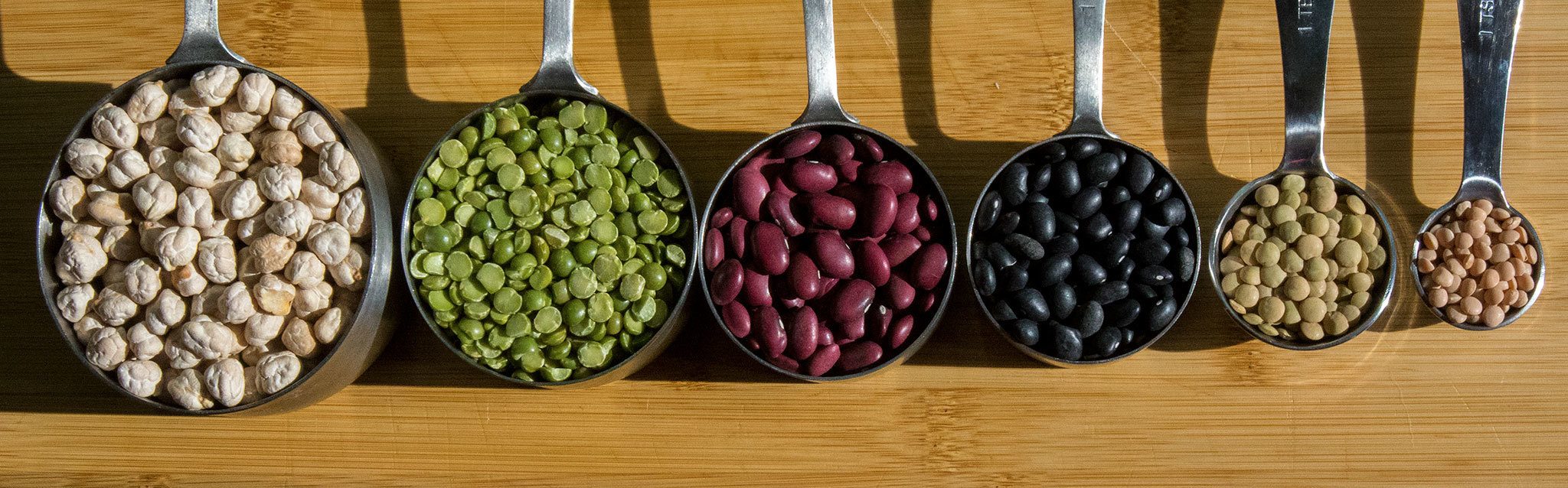 York white garbanzo beans (left), green spilt peas, small red beans, black beans, lentils and sunrise red lentils can be used in breakfast, lunch, dinner and dessert recipes. (Andy Bronson / The Herald)