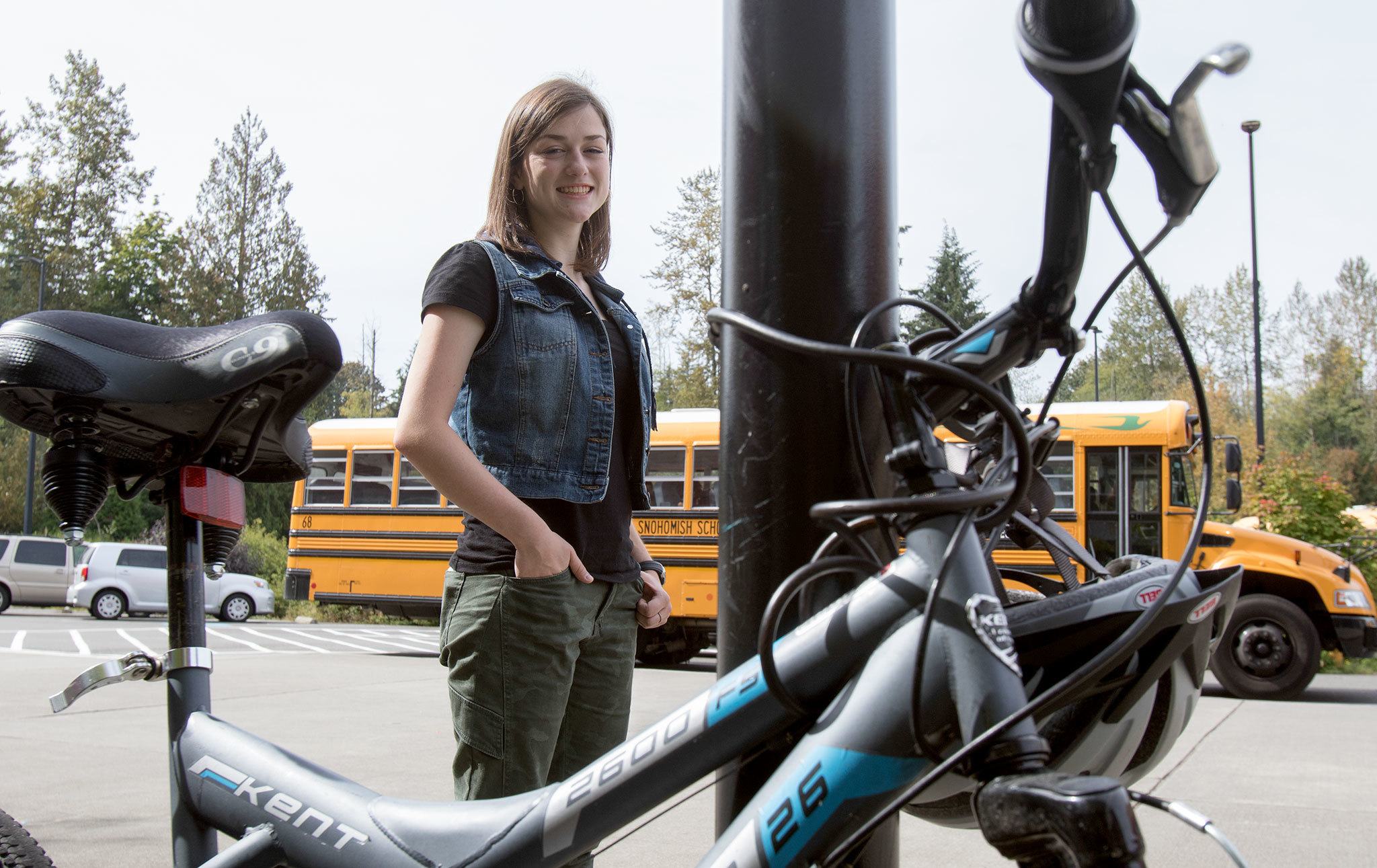 Cars, buses and bikes surround Noelle Forkey, 17, a senior at Glacier Peak High School, in Snohomish on Friday. (Andy Bronson / The Herald)