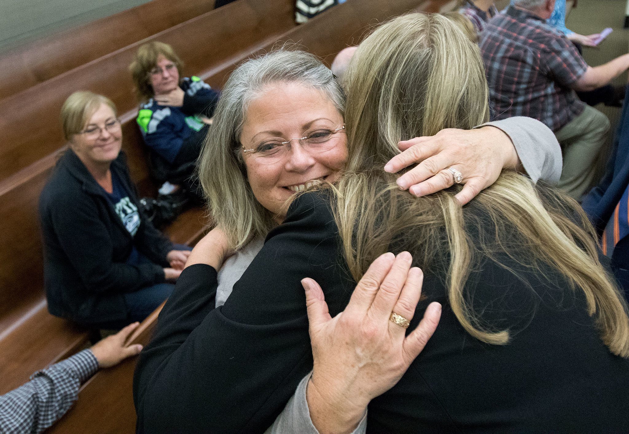 Denise Webber hugs Snohomish County deputy prosecutor Julie Mohr on Friday after John Alan Whitaker was sentenced for a second time for the murder of Webber’s daughter, Rachel Rose Burkheimer. (Andy Bronson / The Herald)