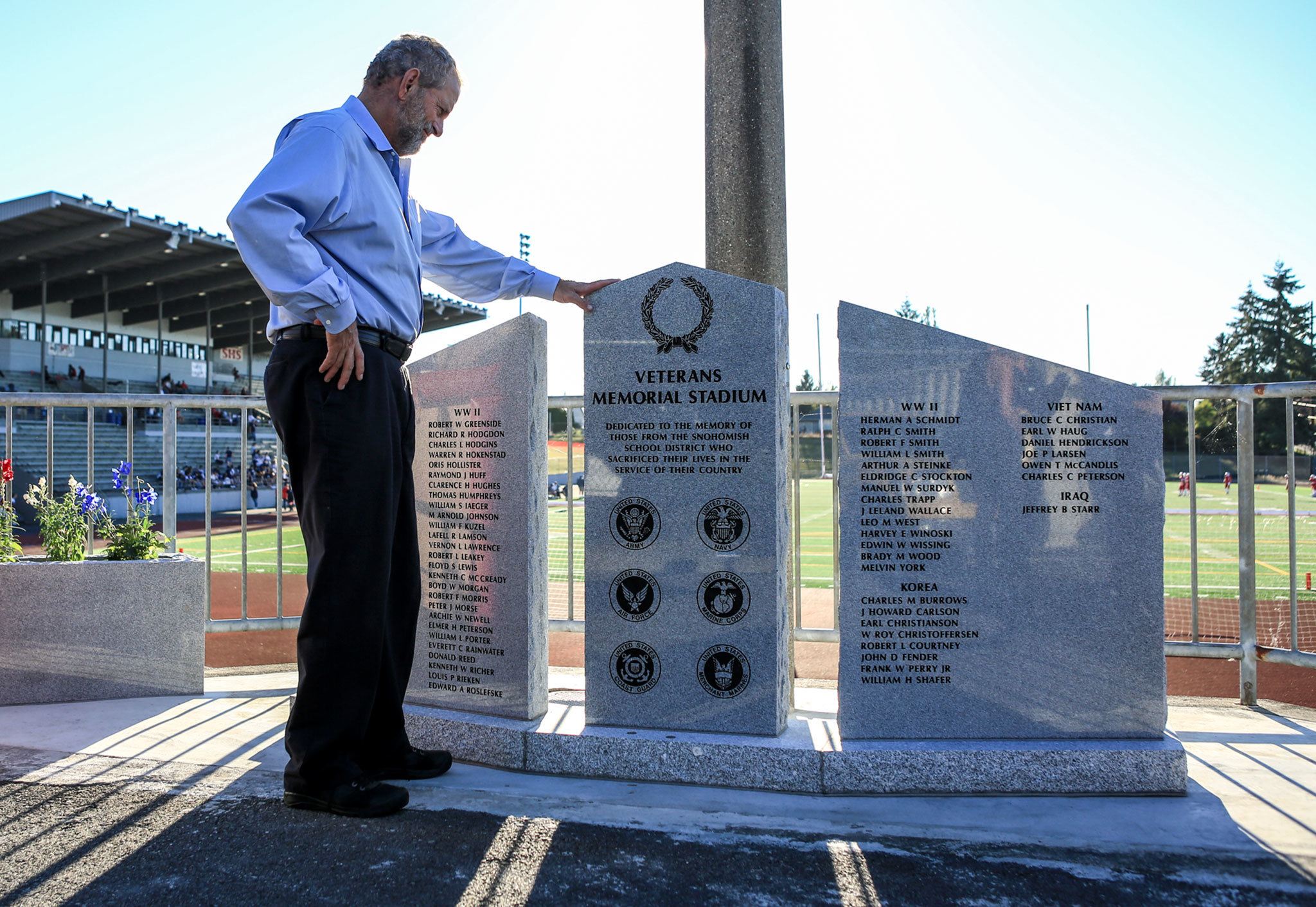 Snohomish County Council member Hans Dunshee looks over the new war memorial Friday afternoon at Veterans Memorial Stadium in Snohomish. (Kevin Clark / The Herald)