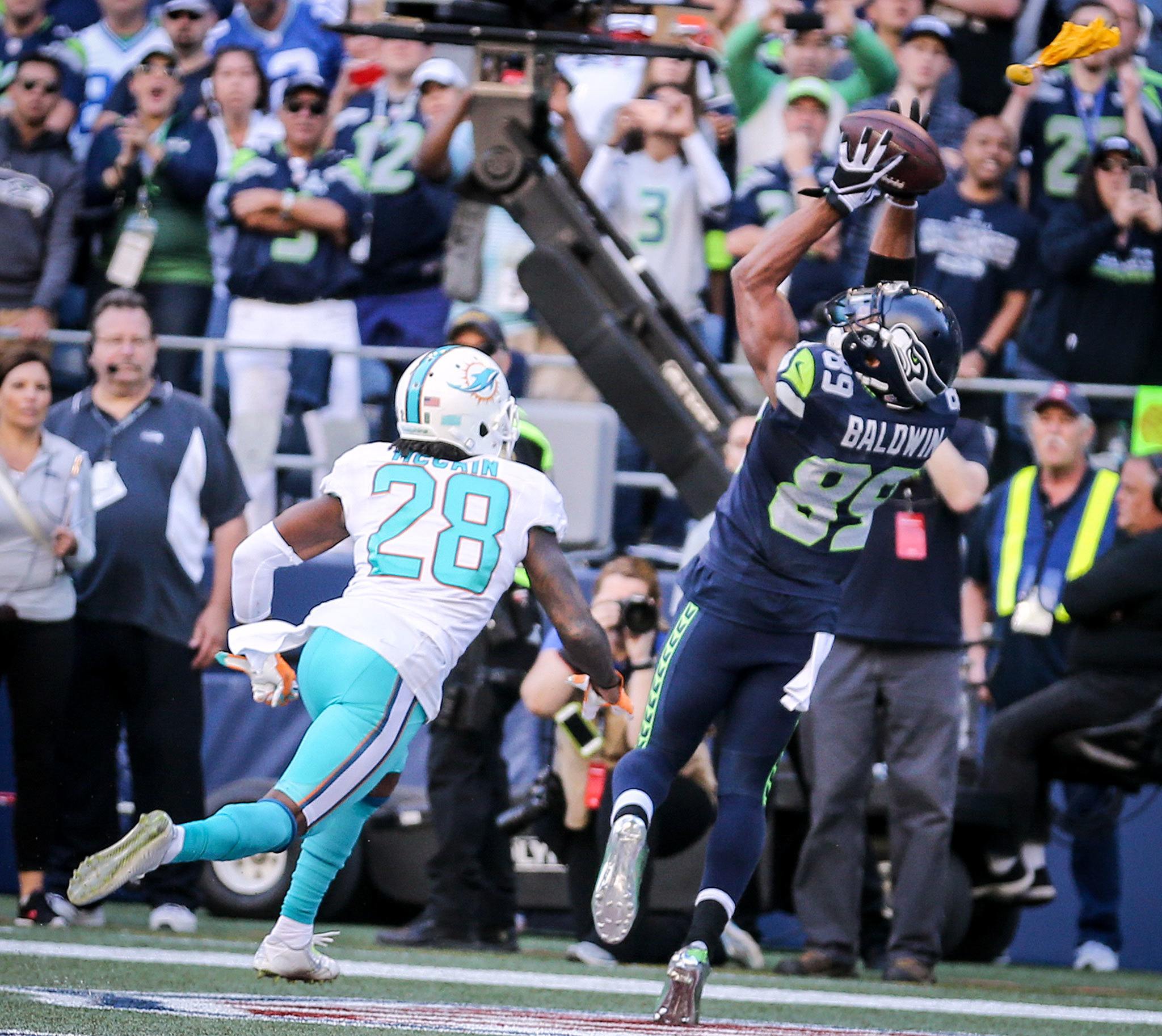 Seahawks wide receiver Doug Baldwin makes the game-winning touchdown reception with Dolphins corner back Bobby McCain trailing in the closing seconds of Sunday’s game at CenturyLink Field. The Seahawks defeated the Dolphins 12-10. (Kevin Clark / The Herald)
