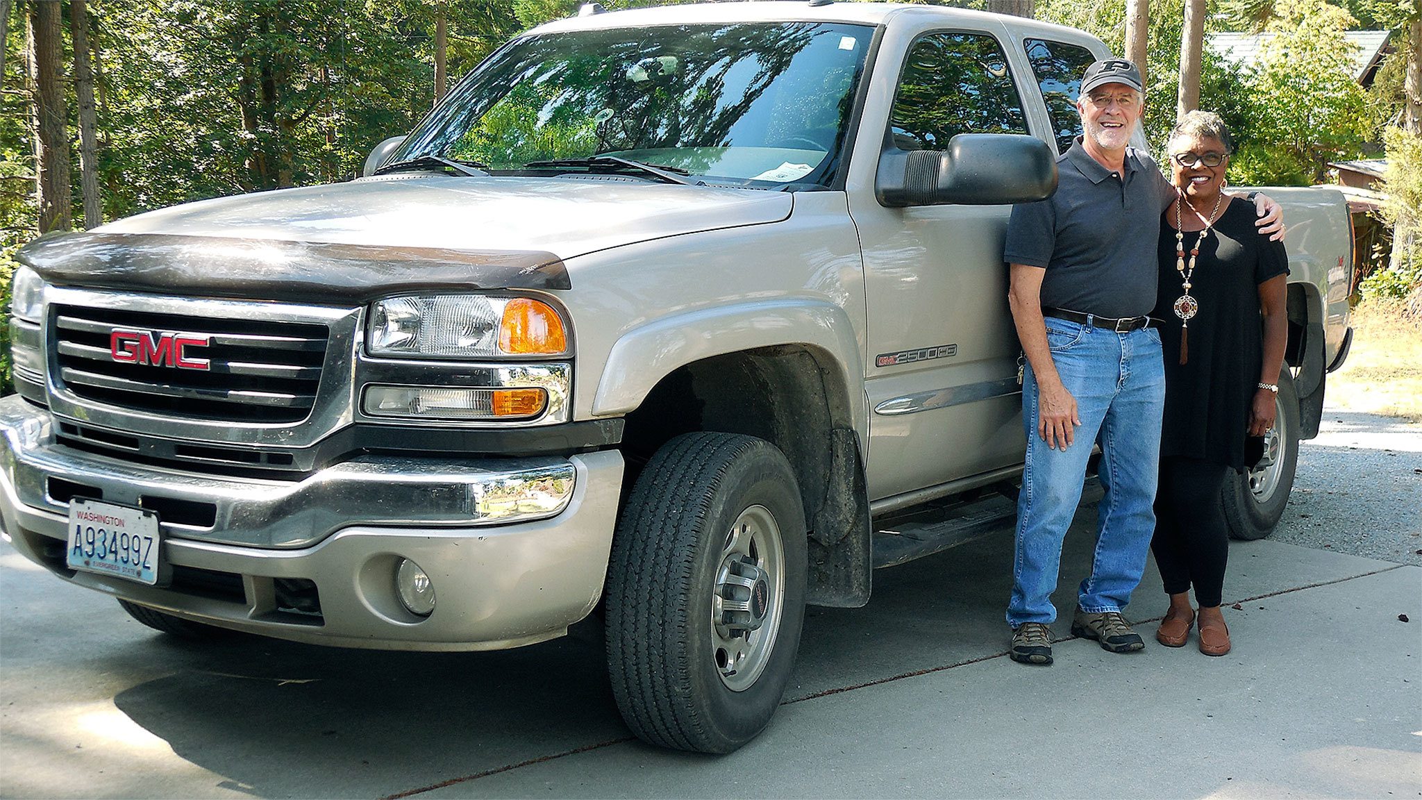 Tim and Carolyn Klein, of Camano Island, stand beside Slurpy, their gas-guzzling yet useful 2005 GMC 2500HD 4WD. (Contributed photo)