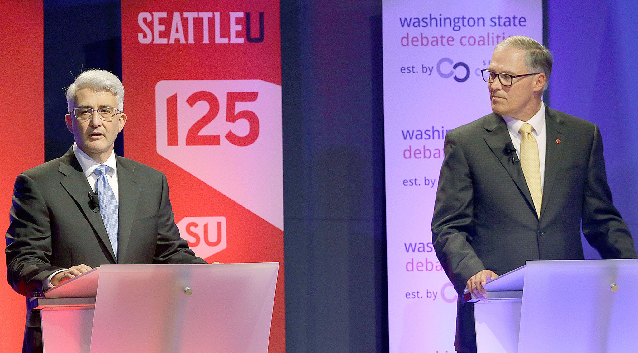 Washington Gov. Jay Inslee (right), a Democrat, and his Republican challenger, Bill Bryant, take part in a debate on Monday in Seattle. (AP Photo/Ted S. Warren)