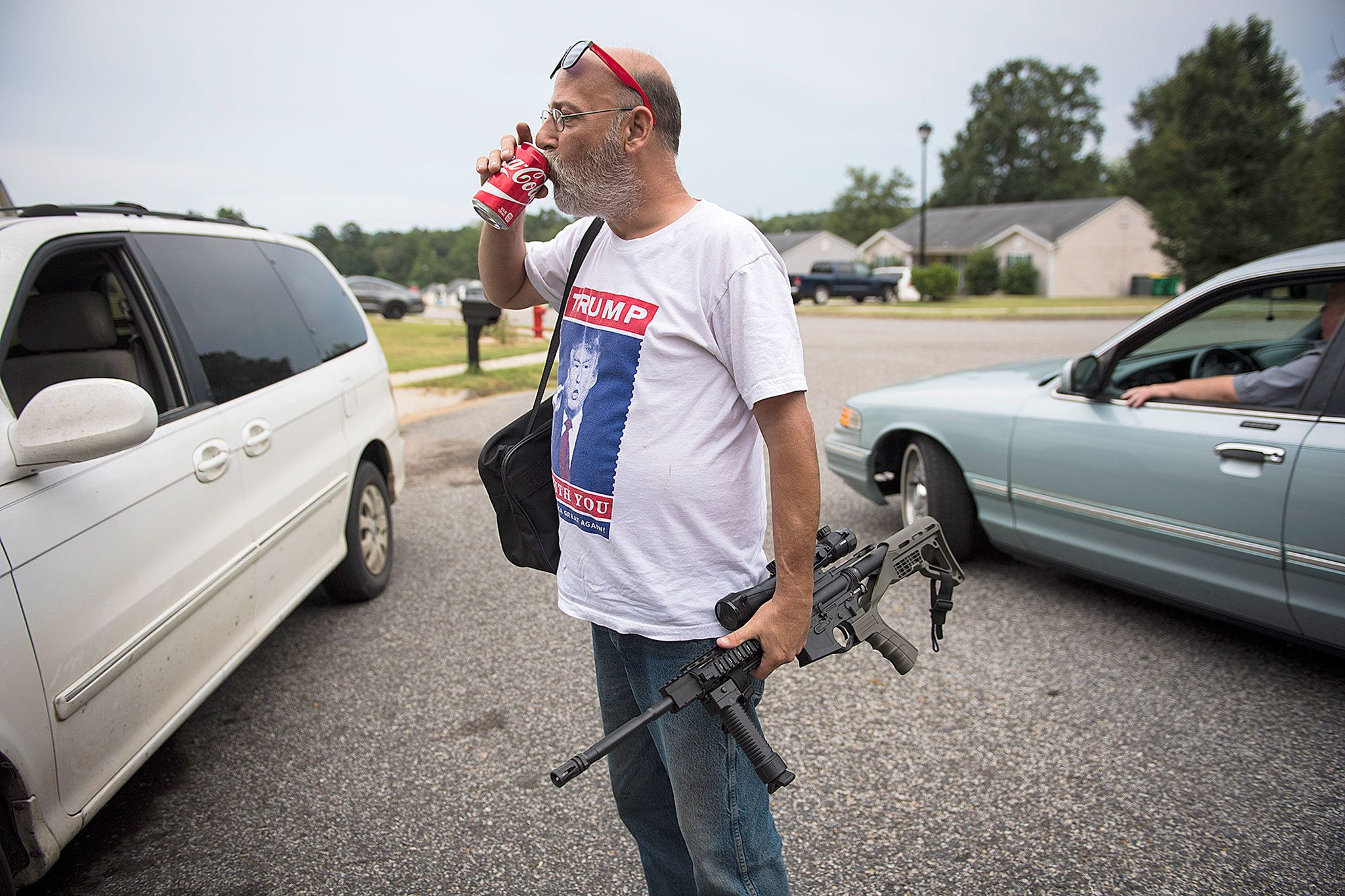 Jim Cooley carries his AR-15 semiautomatic rifle into his home after having it fixed. Cooley almost never leaves his home unarmed. (Washington Post/Jabin Botsford)