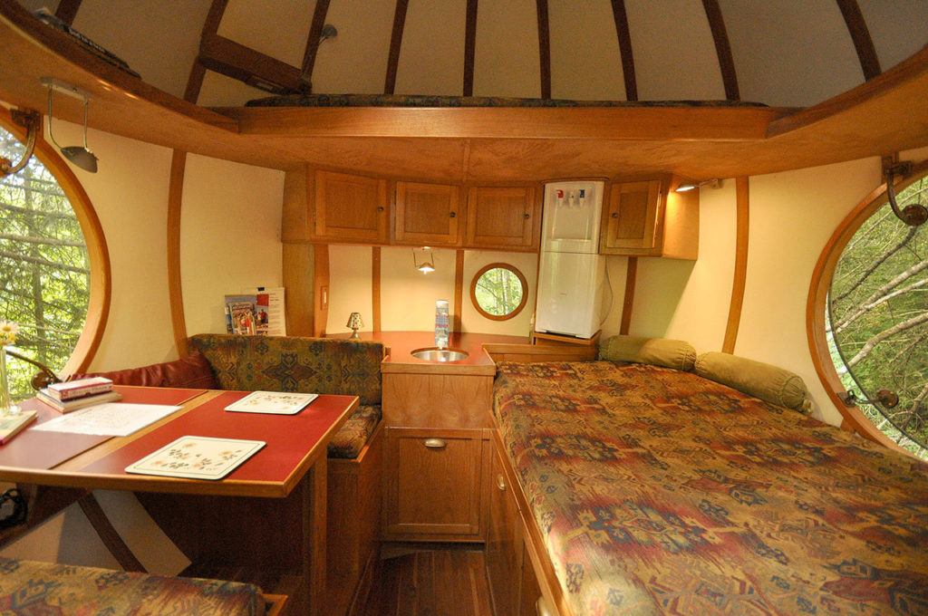 In Vancouver Island’s rain forest, a treehouse hotel is fit for a hobbit. Show is the Eryn sphere’s interior as seen from the doorway with bed to the right and table to the left. (Photo by Adam Clarke)
