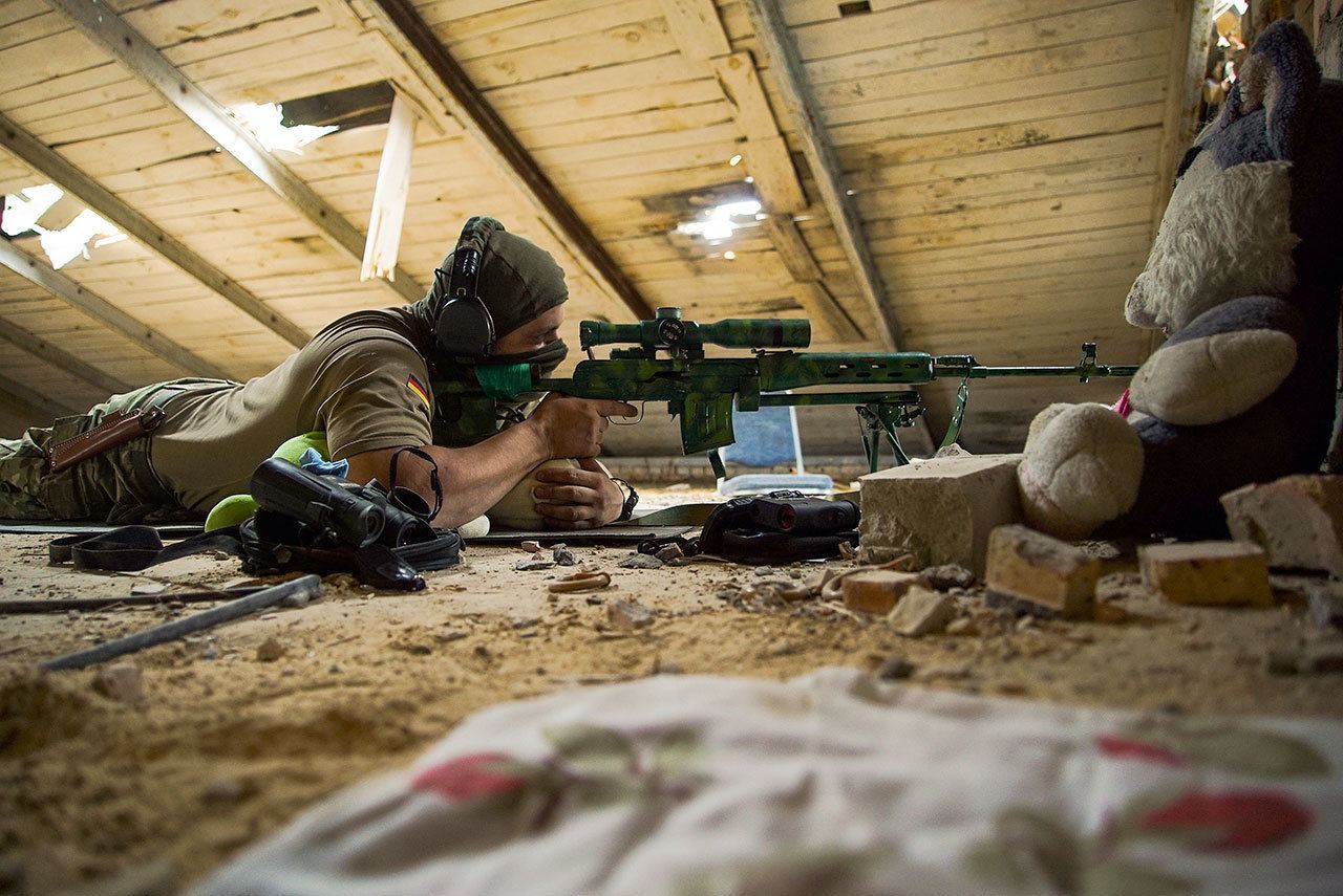A Ukrainian sniper takes his position in the village of Marinka, near Donetsk, eastern Ukraine, on Aug. 25. More than 9,500 people have been killed in the fighting that began in April 2014, according to United Nations figures. (AP Photo/Max Black)