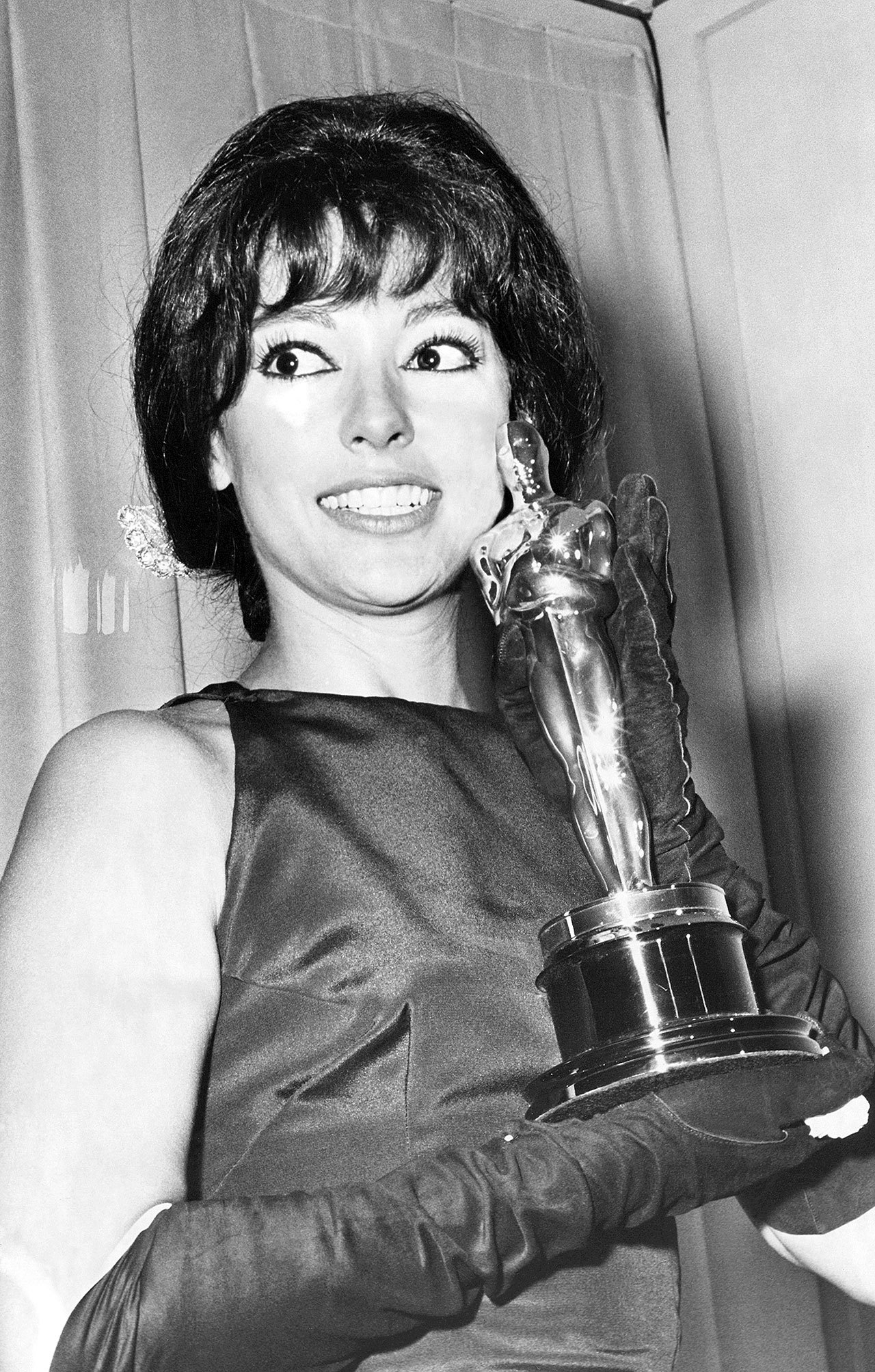 Rita Moreno holds the Oscar she won in 1962 as best supporting actress for her role in “West Side Story.” (Associated Press)
